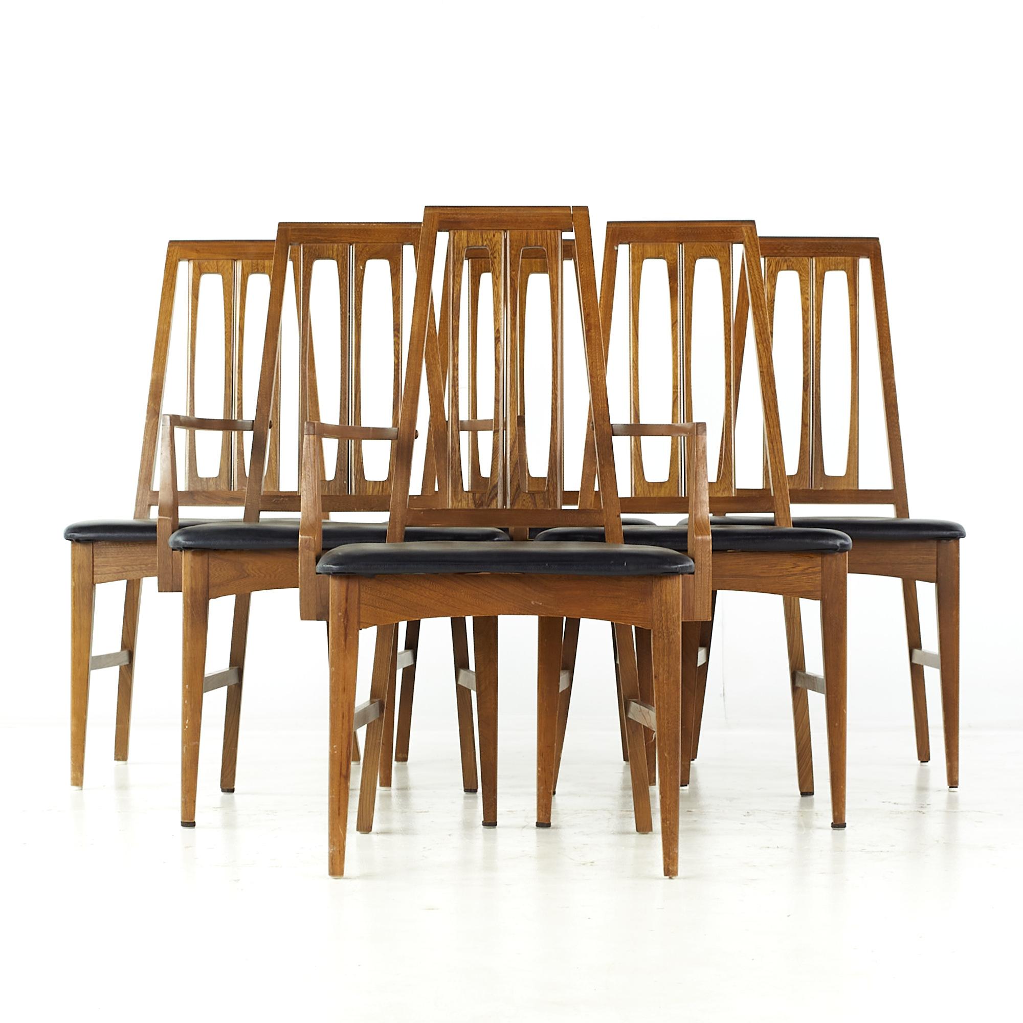 Young Manufacturing mid century walnut dining chairs - set of 6

Each armless chair measures: 19.5 wide x 20 deep x 38.25 high, with a seat height of 18.5 inches
Each captains chair measures: 22.75 wide x 22 deep x 38.25 high, with a seat height