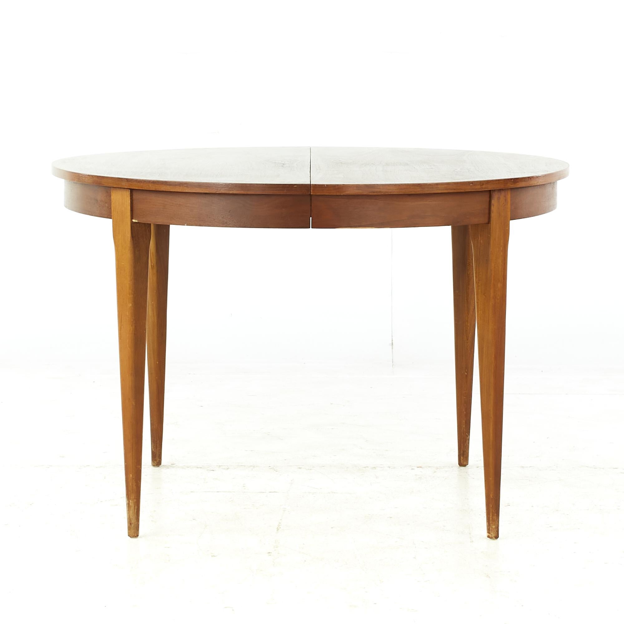 Young Manufacturing midcentury walnut dining table with 2 leaves

This table measures: 44.25 wide x 44 deep x 29.25 high, with a chair clearance of 25.5 inches, each leaf measures 18 inches wide, making a maximum table width of 80.25 inches when