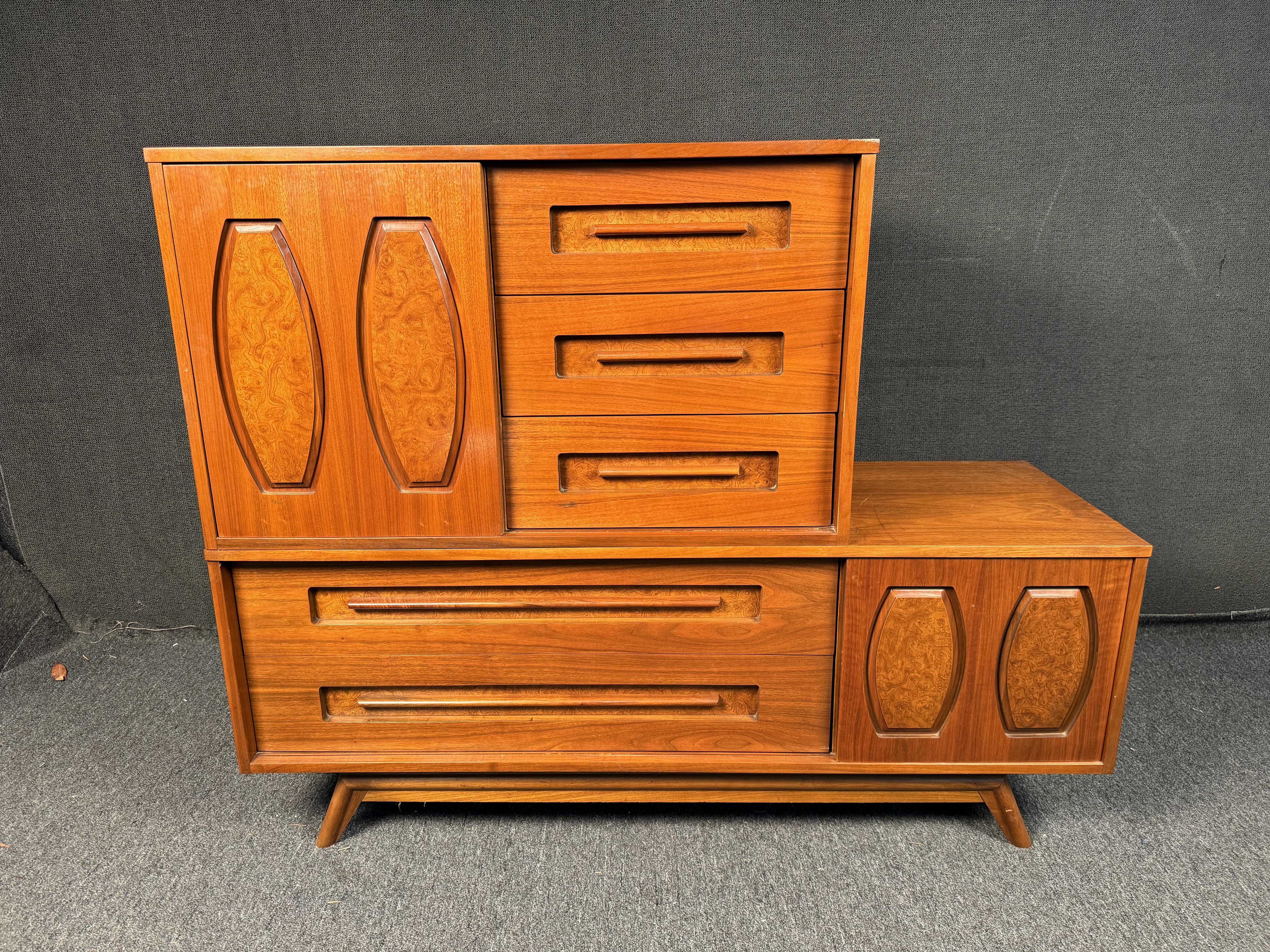 Stunning Midcentury modern large Gentleman's Chest from Young Manufacturing Company. This walnut dresser features burled inserts on the sliding doors, which open to reveal an additional five drawers. The sculpted lines throughout this piece make