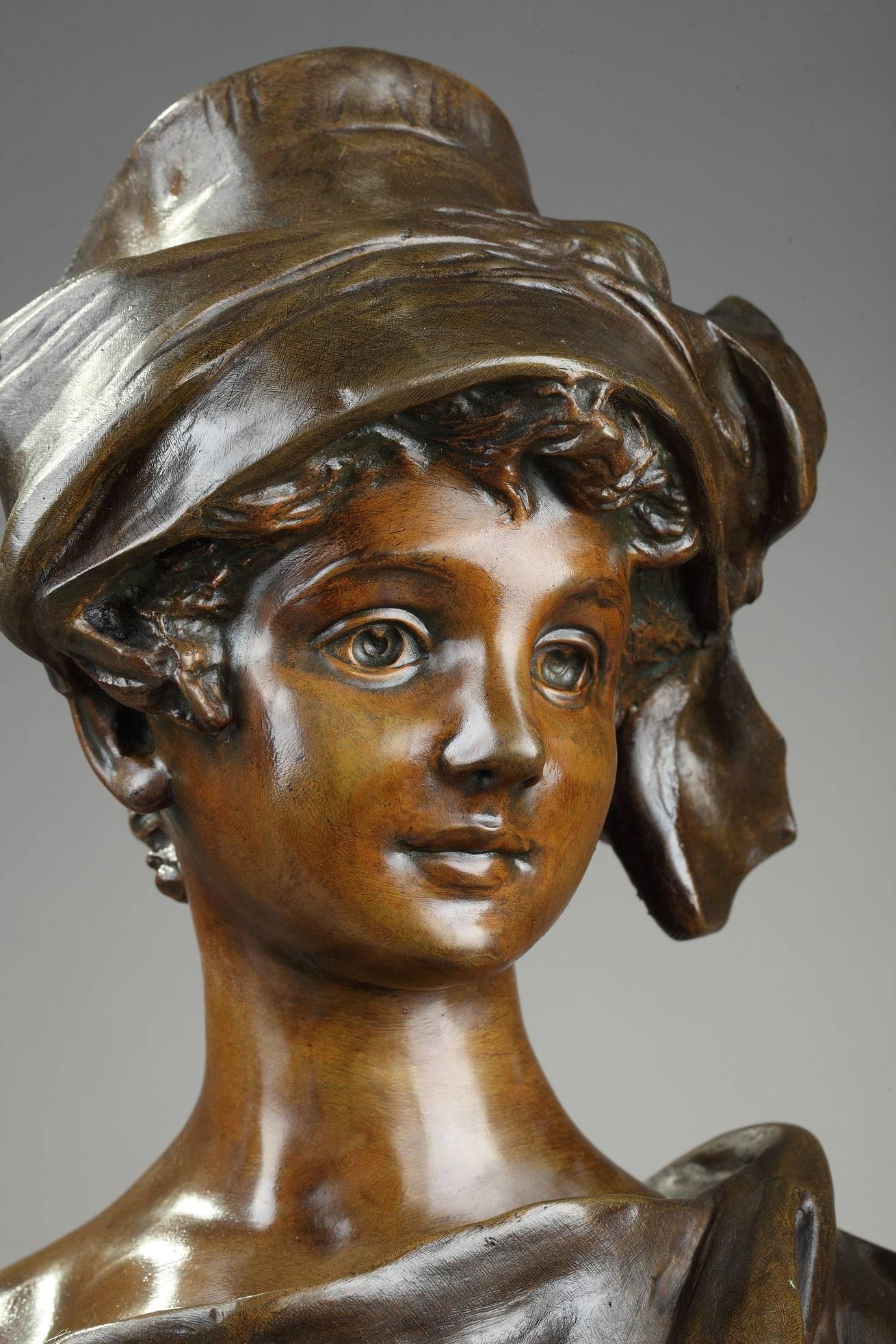 Late 19th century patinated bronze sculpture featuring the bust of a smiling woman by the Belgian sculptor Georges Van der Straeten (1856-1928). She is wearing an elegant hat decorated with ribbon. Signed in the back: van der Straeten. Foundry mark:
