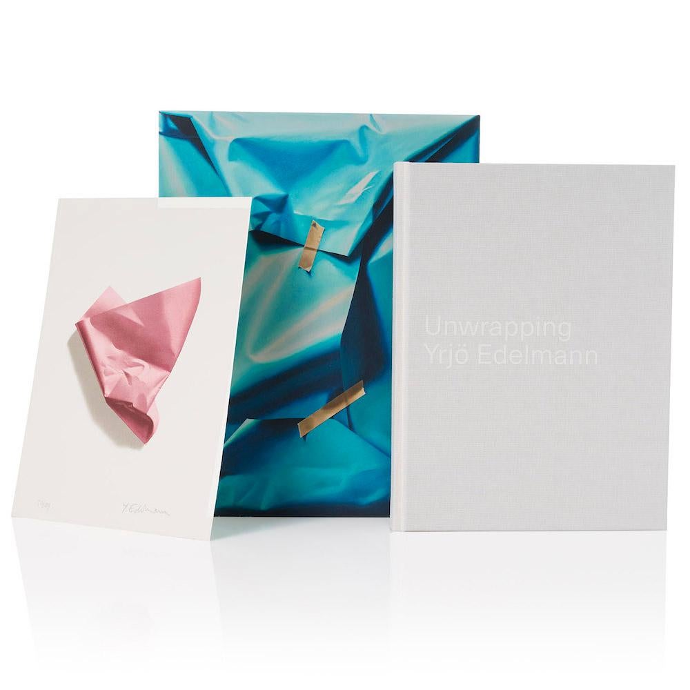 Please note that the paper object on the print can be of different shapes. 
Box size 38x30cm. Limited edition of 200 ex.

Unwrapping Yrjö Edelmann is a tribute to the artist who amazes the world with his trompe l’œil painting. The book takes you