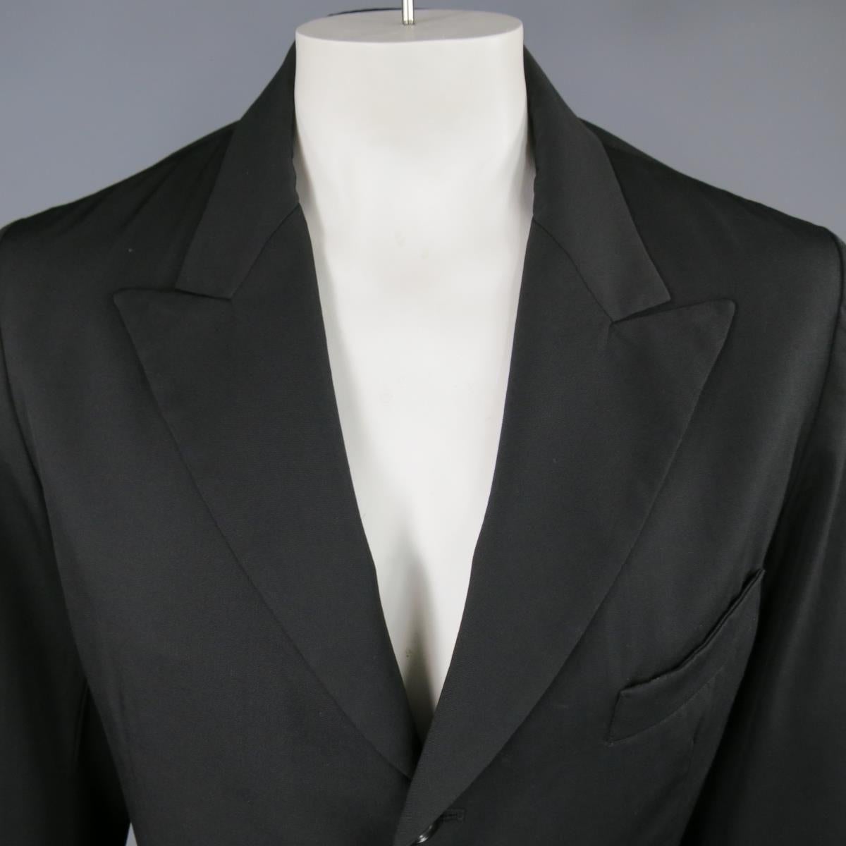 Y'S by YOHJI YAMAMOTO Sport Coat consists of 100% wool material in a black color tone. Designed with a peak-lapel collar, 3-button front, bottom inseam pockets with top pocket square. Tone-on-tone stitching throughout coat with 2-button cuffs and no