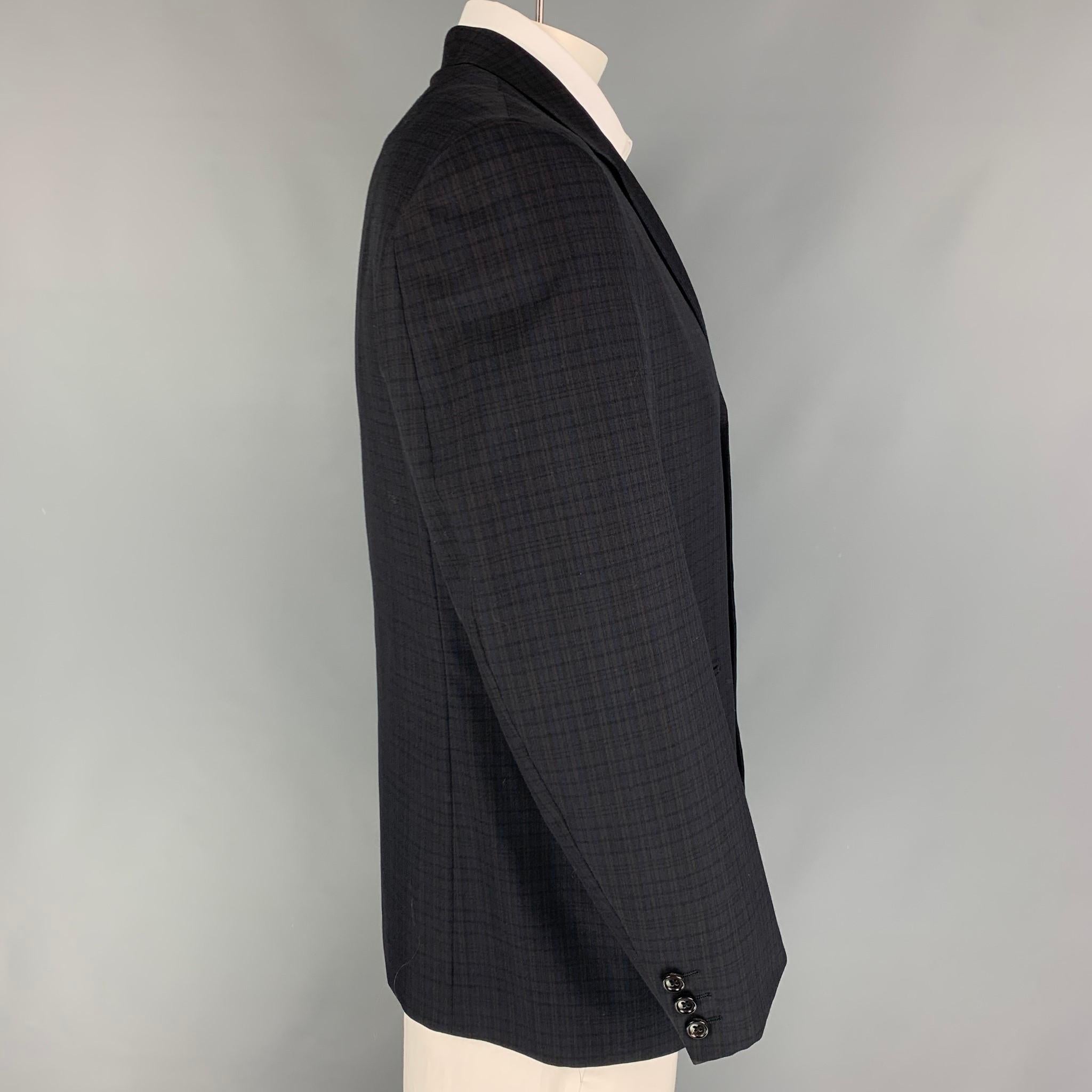 Y'S by YOHJI YAMAMOTO sport coat comes in a black & brown checkered wool / polyester with a full liner featuring a notch lapel, slit pockets, and a three button closure. Made in Italy. 

Very Good Pre-Owned Condition.
Marked: