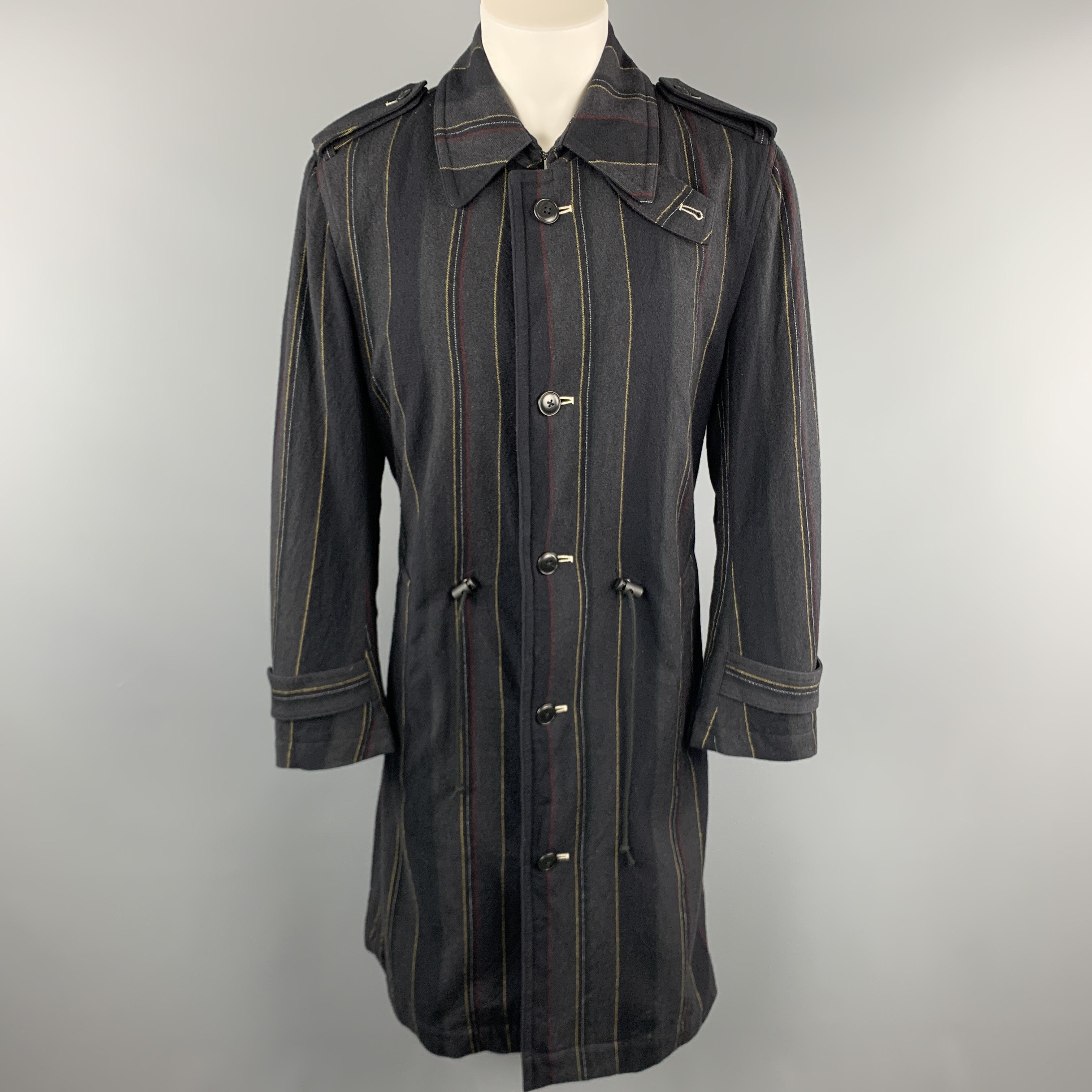Y'S by YOHJI YAMAMOTO trench coat comes in charcoal striped wool with an oversized collar, epaulets, single breasted button front, drawstring waist, and belt. 

Excellent Pre-Owned Condition.
Marked: JP 3

Measurements:

Shoulder: 17 in.
Chest: 46