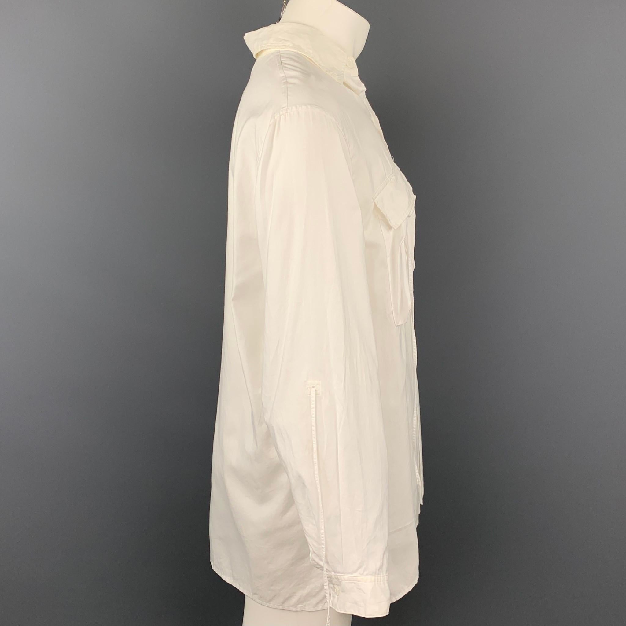 Y's by YOHJI YAMAMOTO long sleeve shirt comes in a white cotton featuring a oversized button up style, patch pockets, drawstring detail, and a spread collar. Made in Japan.

Very Good Pre-Owned Condition.
Marked: 1

Measurements:

Shoulder: 18