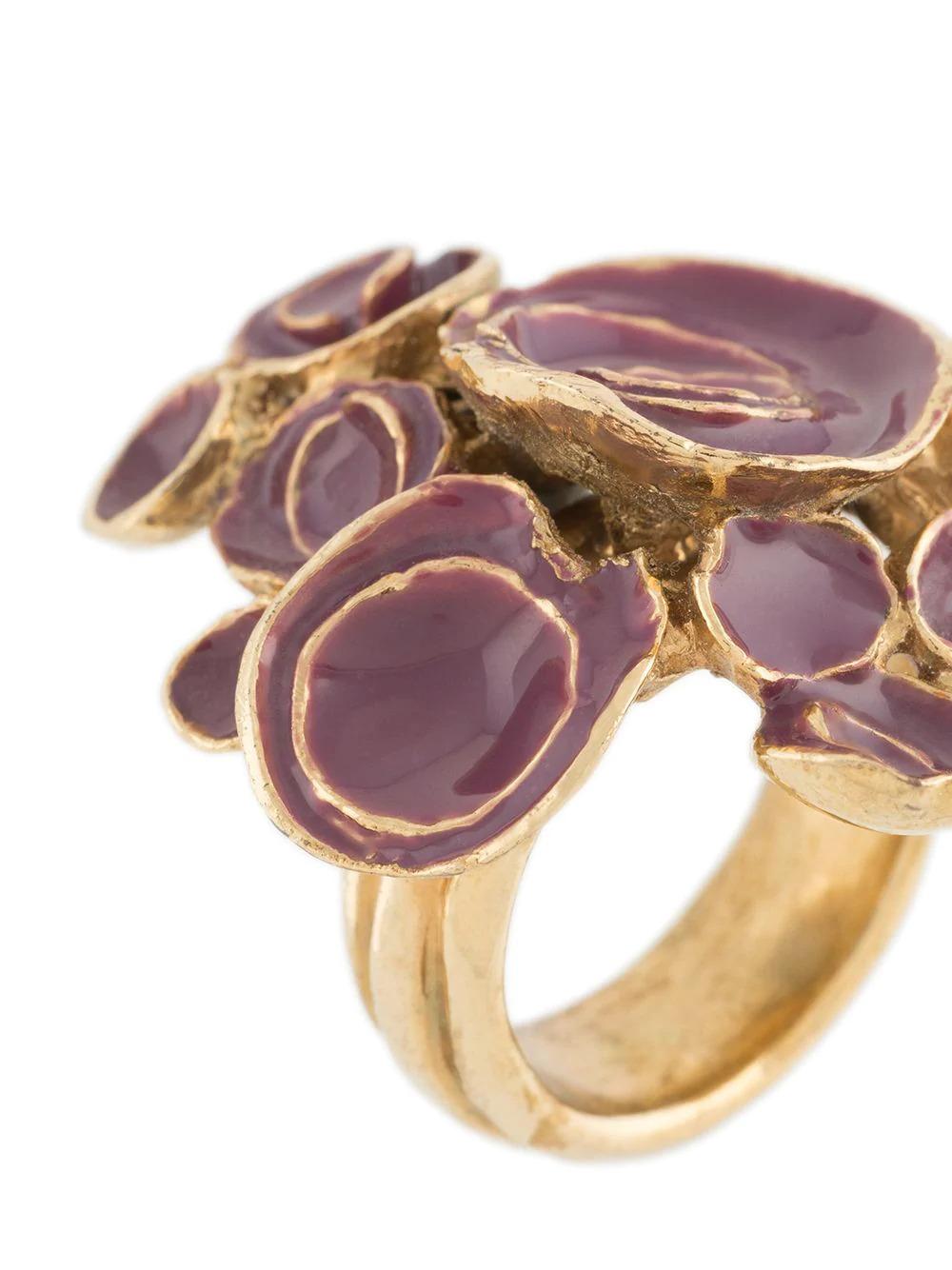 Mauve and gold ring from Yves Saint Laurent. Featuring an abstract design and crafted from gold plated metal. 	

Colour: Purple & Gold	

Composition: Gold plated metal	

Condition:  Very good vintage condition 8/10. Consistent with age, visible