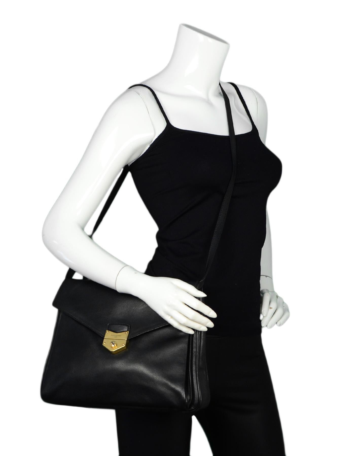 YSL Black Leather Envelope Dandy Maxi Flap Crossbody Bag

Made In: Italy
Year of Production: 2012
Color: Black, gold
Hardware: Goldtone
Materials: Leather, metal
Lining: Black textile
Closure/Opening: Flap top with pushlock closure
Exterior Pockets: