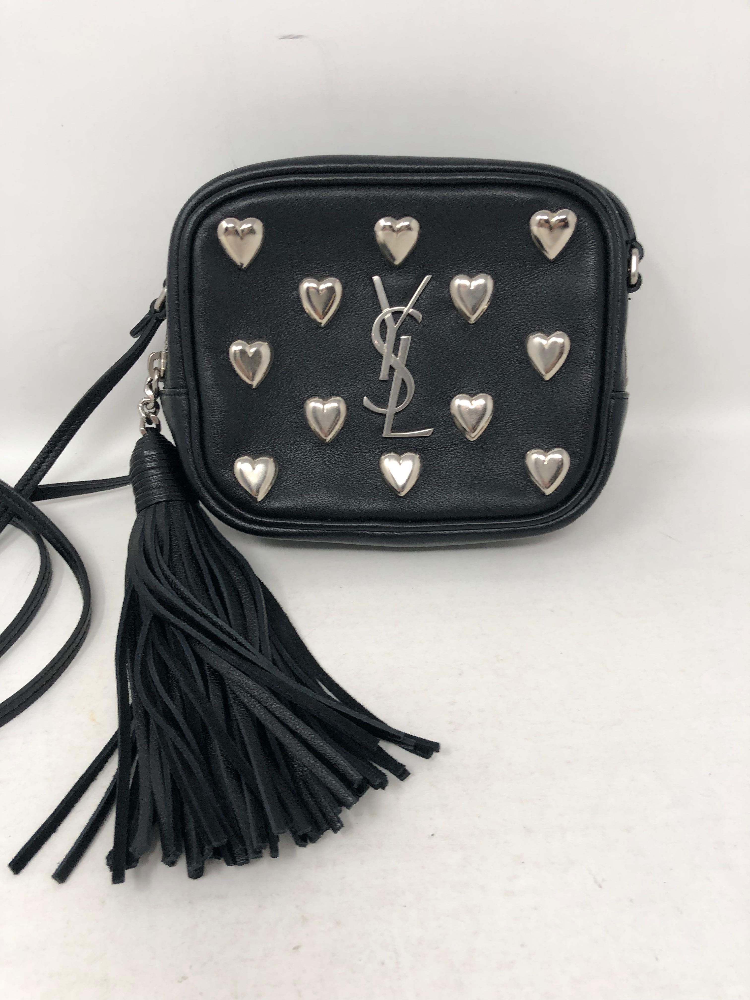 Yves Saint Laurent Black Mini with silver hearts crossbody bag. New condition. Cute tassel on side. All leather with silver studded hearts. Guaranteed authentic. 