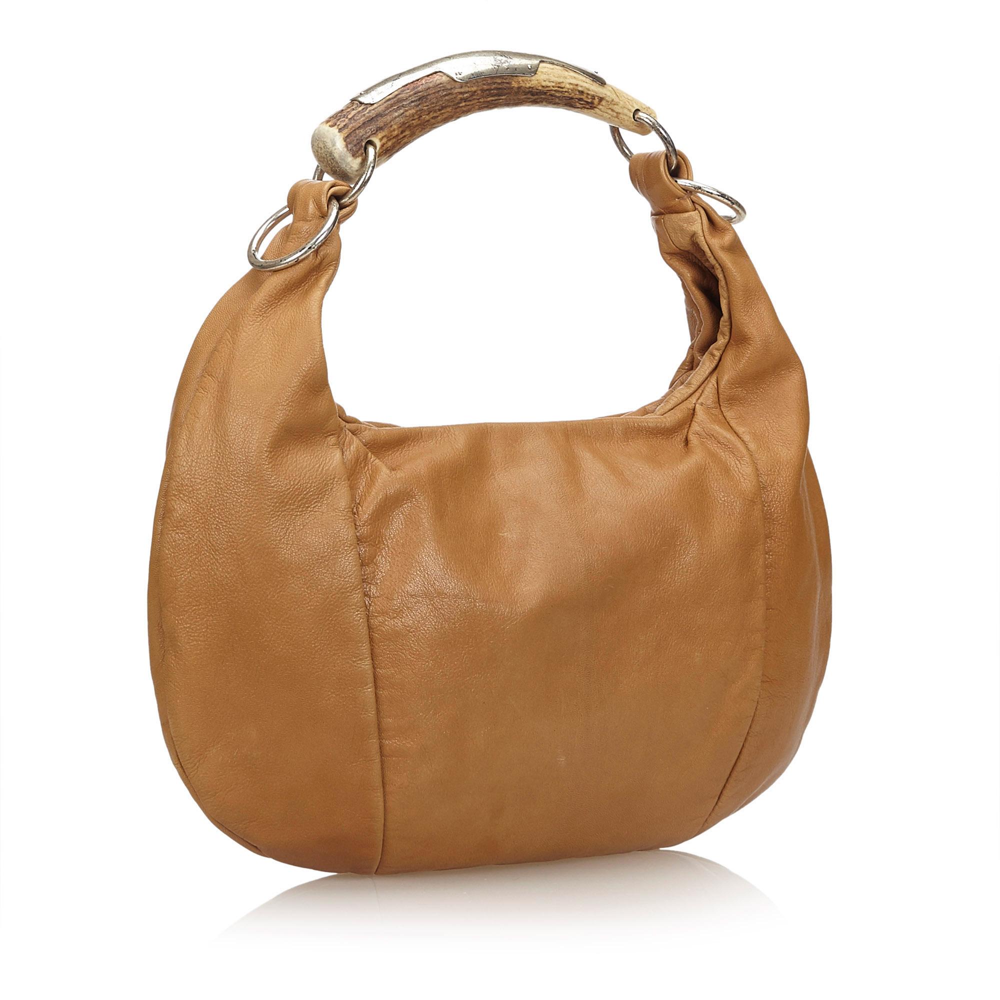 This bag features a leather body, wooden handle, flat leather strap, top zip closure, and interior zip and slip pocket. It carries as B condition rating.

Inclusions: 
This item does not come with inclusions.

Dimensions:
Length: 24.00 cm
Width: