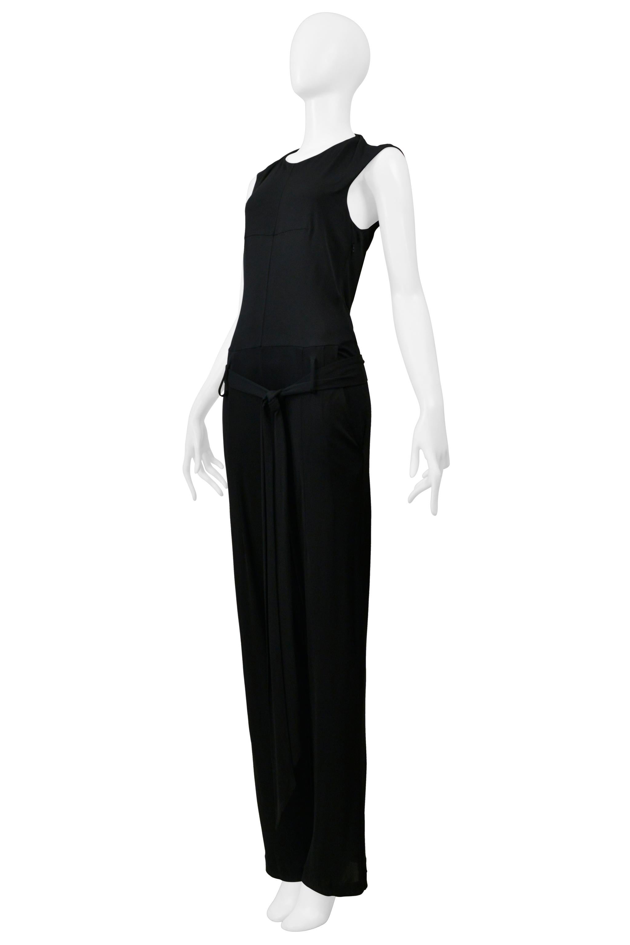 Resurrection is excited to offer a vintage YSL by Stefano Pilati black viscose jumpsuit featuring cap sleeves, hook-and-eye closures on the back, full length, and belted waist. 

YSL by Stefano Pilati
Size 34
Fabric: 100% Viscose

Very Good Vintage