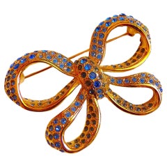 YSL Gilt Metal and Blue Crystal Stones Bow Brooch, Vintage 1980s