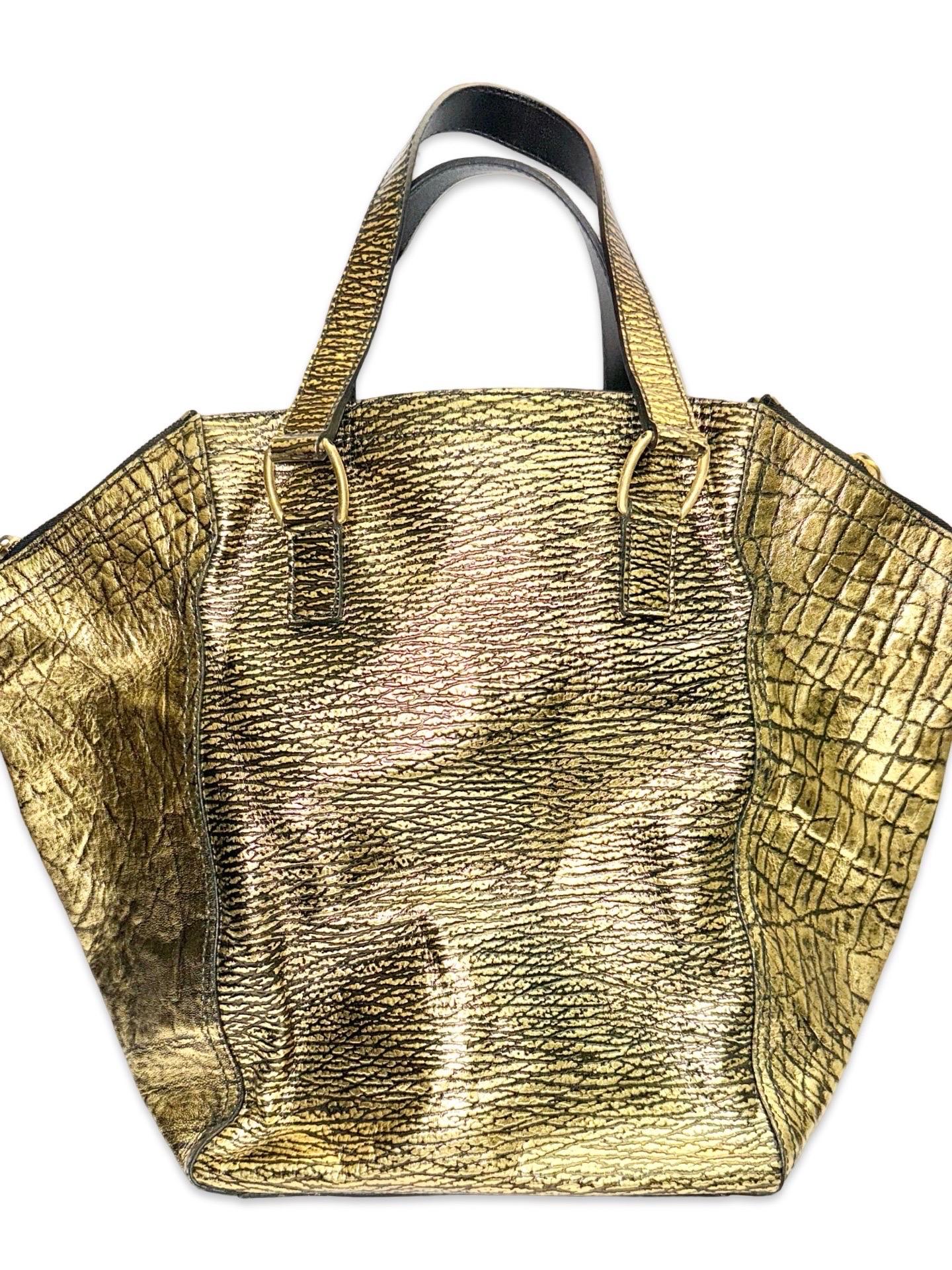 - YSL gold pattern leather tote bag from Stefano Pilati era. 

- Front buckles details.

- Gold zippers details. 

- Silk interior zip pocket.

- Length: 10 inches. Extended total length: 17 inches. Width: 10 inches. Height: 14 inches. Handle Drop: