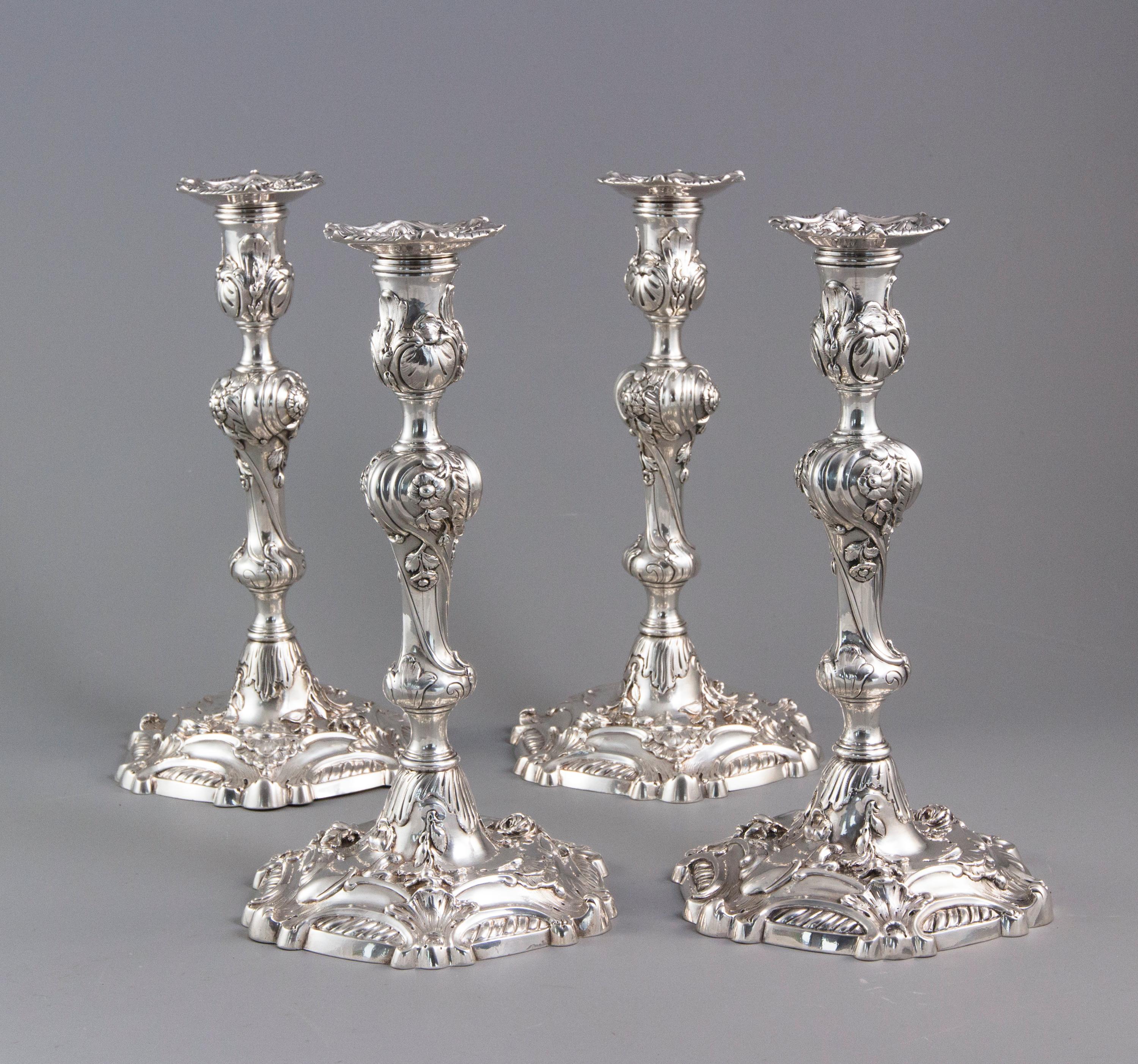 This beautiful set of four cast George II silver candlesticks are designed in the Rococo style and came from the personal collection of Yves Saint Laurent & Pierre Bergé.

Each with shaped, circular base with cast shell and floral decoration. The
