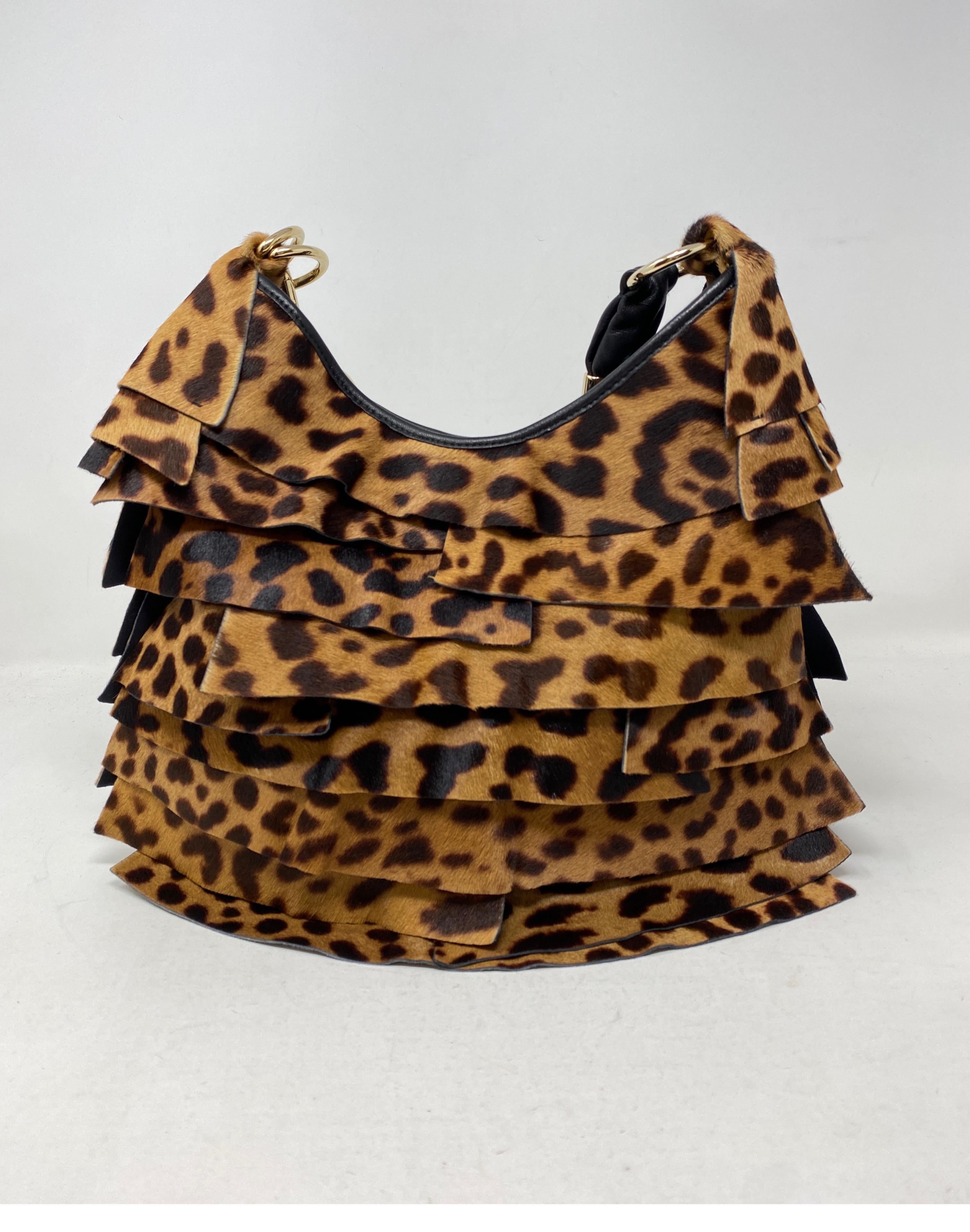 Yves Saint Laurent Leopard Purse. Layered leopard colored leather in hobo style bag. Nice black leather handle. Gold hardware. Mint like new condition. Unique fun bag. Guaranteed authentic. 