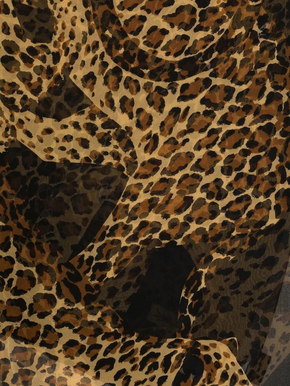 In a lovely slightly sheer silk, this leopard print Yves Saint Laurent scarf is sure to make a statement. Add an exotic touch to your YSL bag handle or with an all-black Parisian look. Features a small YSL logo at the top corner, large in size.
