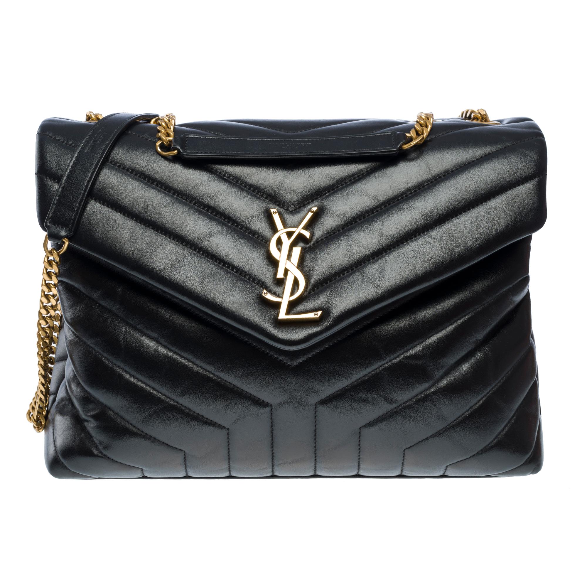 Saint​ ​Laurent​ ​Loulou​ ​medium​ ​model​ ​(MM)​ ​quilted​ ​chevron​ ​leather​ ​shoulder​ ​bag​ ​in​ ​black,​ ​with​ ​gold​ ​metal​ ​trim,​ ​a​ ​convertible​ ​gold​ ​metal​ ​chain​ ​handle​ ​allowing​ ​for​ ​shoulder​ ​or​ ​crossbody​ ​wear.

Flap​