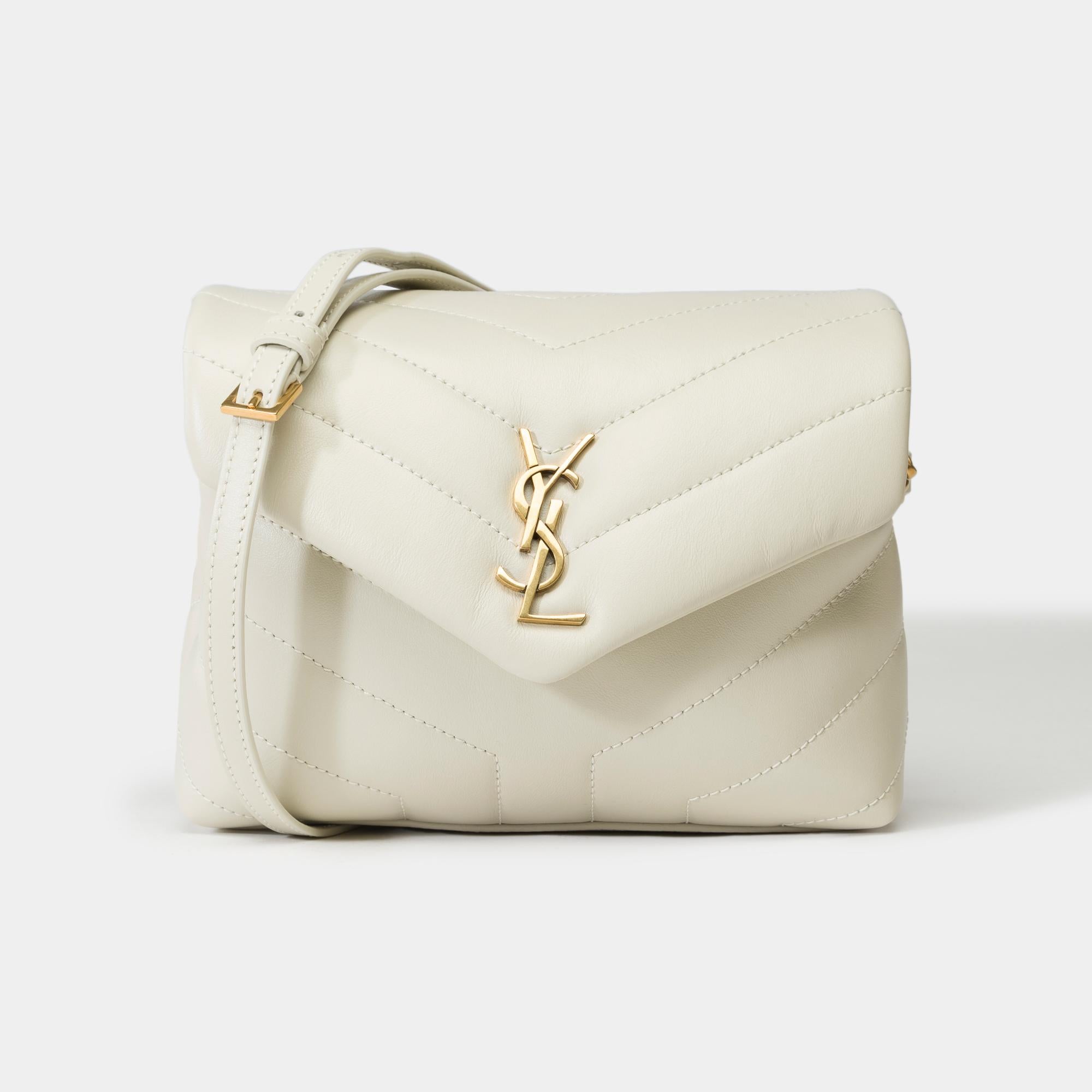 Stunning​ ​Yves​ ​Saint​ ​Laurent​ ​Loulou​ ​Toy​ ​bag​ ​in​ ​beige​ ​quilted​ ​calf​ ​leather​ ​and​ ​light​ ​bronze​ ​brass​ ​trim.​ ​It​ ​has​ ​two​ ​compartments,​ ​a​ ​removable​ ​and​ ​adjustable​ ​shoulder​ ​strap​ ​that​ ​allows​ ​a​