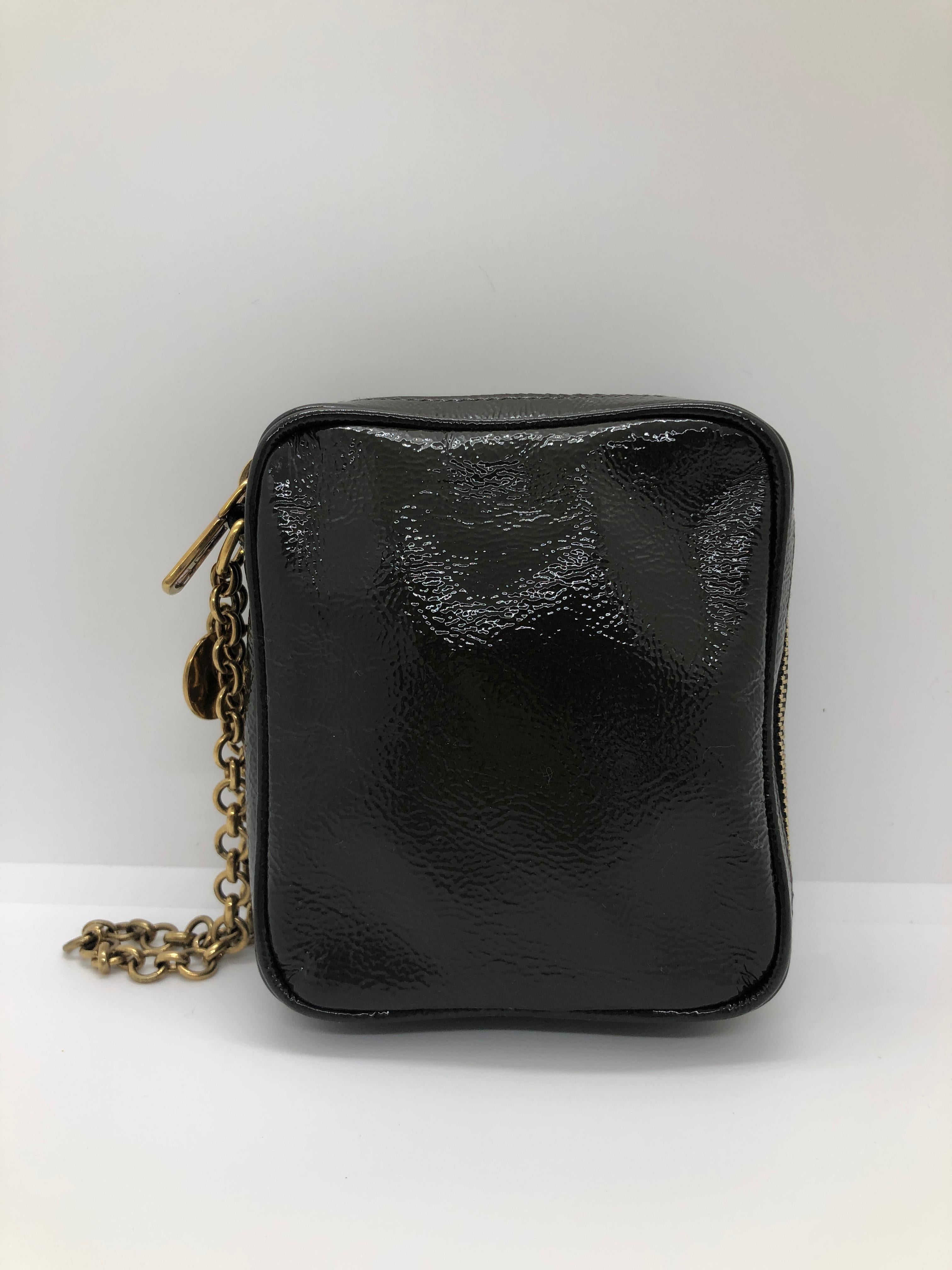 Make:  Yves Saint Laurent
Place of Manufacture:  Italy
Color:  Gray and gold
Materials:  Patent leather and gold tone metal
Condition:  Very good minor use condition
Type:  Wristlet / pochette
Style:  Offered is a YSL monogrammed gunmetal gray