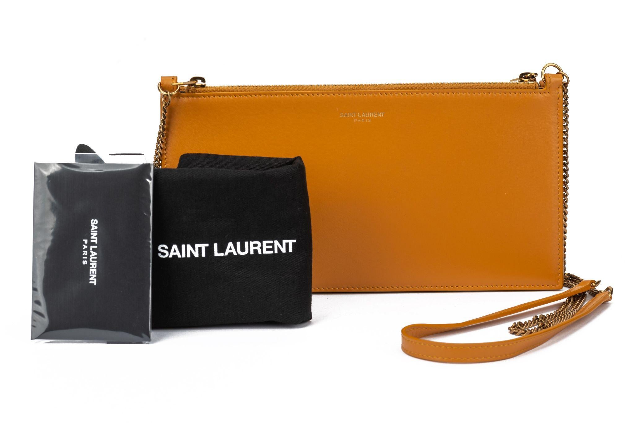 Yves Saint Laurent Leather Double Pouch on Chain Cross body Bag in dark yellow. The bag is crafted out of durable calfskin leather with a removable chain strap with leather shoulder pad. Shoulder drop 22”.  The bag is new and comes with the original