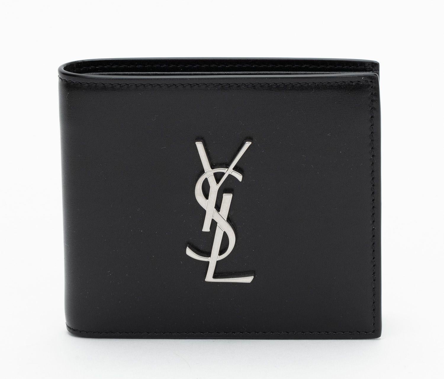 YSL New Black leather bifold wallet with palladium metal YSL logo on the front.
10 card slots and two compartments inside.
Comes with booklet, original dust cover and original box.