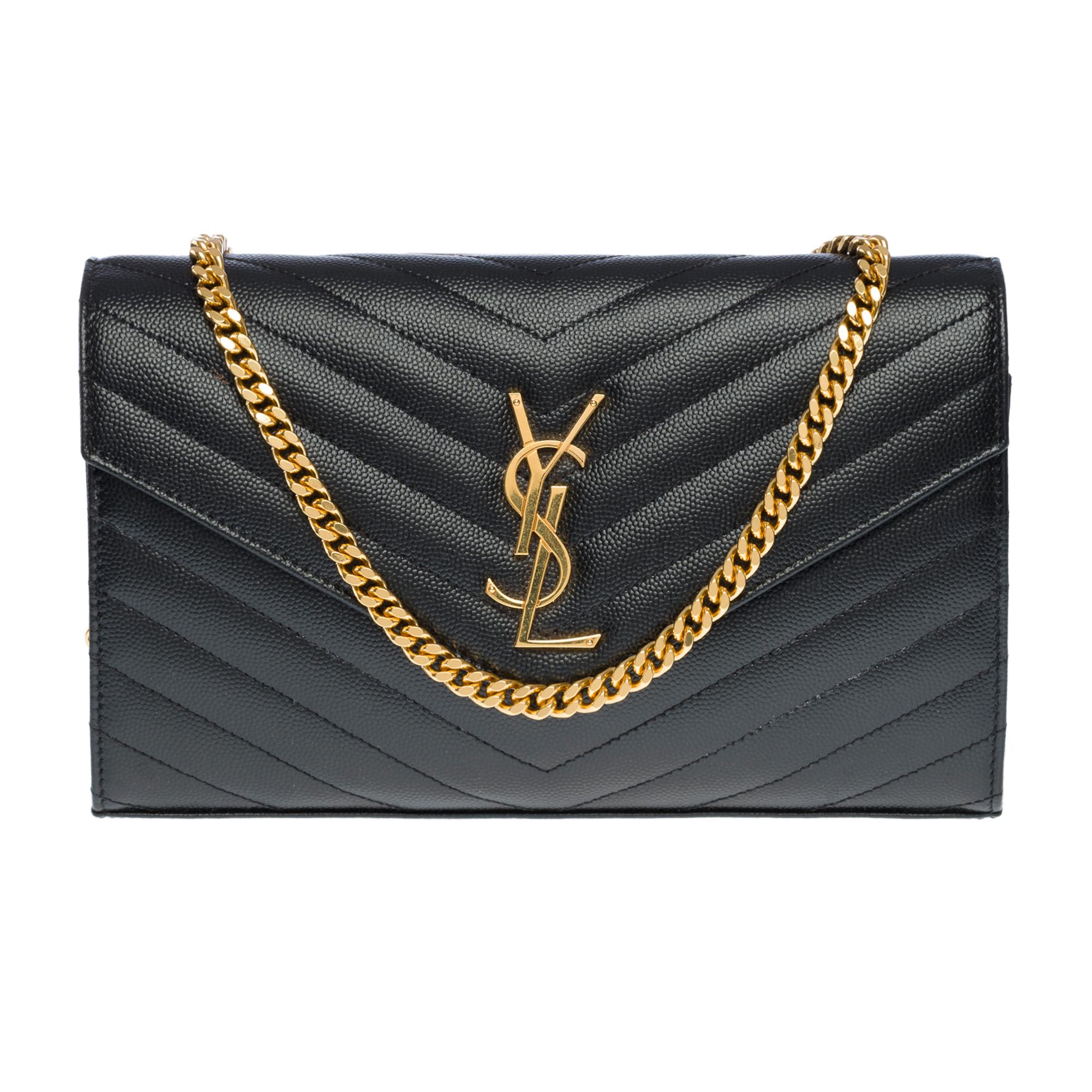 Gorgeous​​​ ​​​Timeless​​​ ​​​YSL​​​ ​​​Enveloppe​​​ ​​​Cassandre​​​ ​​​classic​​​ ​​​gold​​ ​​​chain​​​ ​​​adorned​​​ ​​​with​​​ ​​​Cassandre​​​ ​​​and​​​ ​​​stitched​​​ ​​​with​​​ ​​​the​​​ ​​​iconic​​​ ​​​quilted​​​ ​​​black​​ ​​​grained​​​