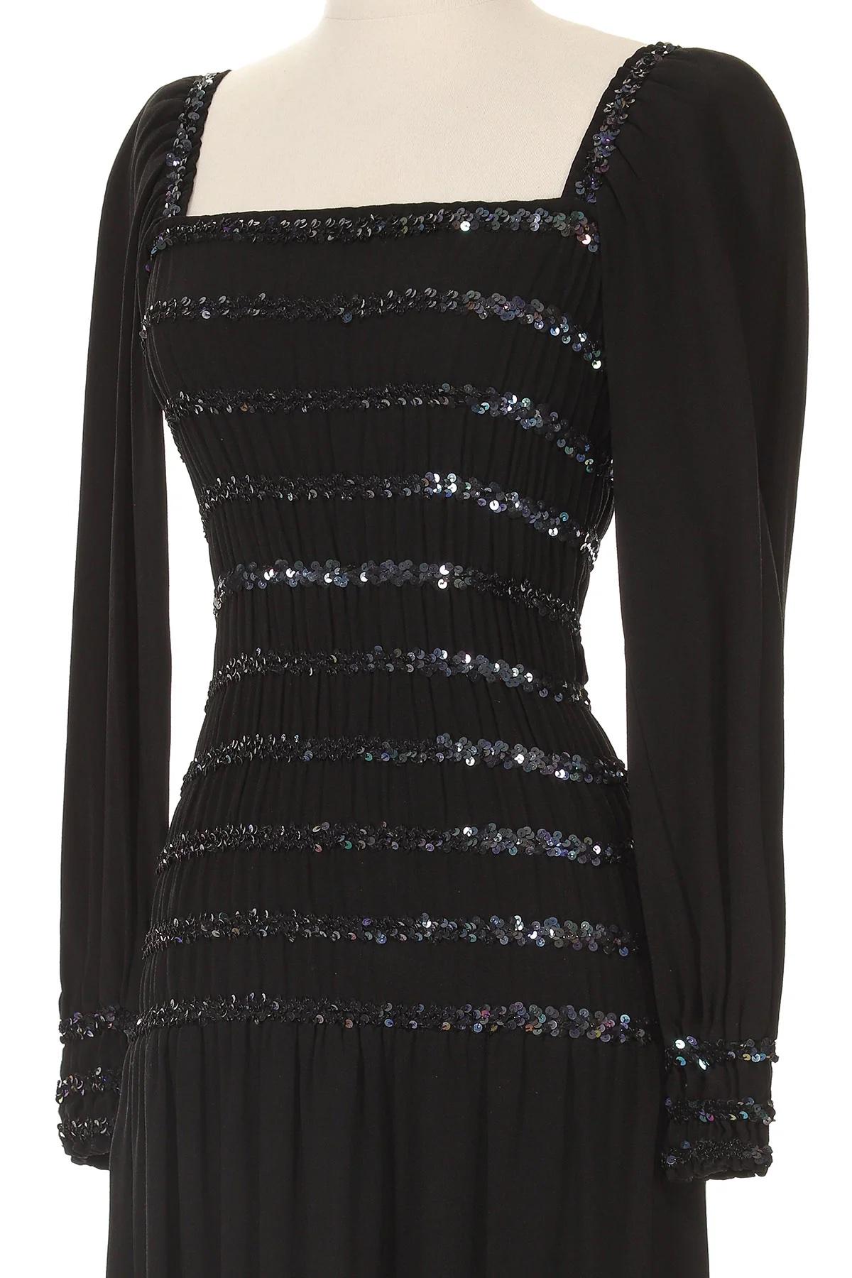 VINTAGE GRACE NY

Yves Saint Laurent Rive Gauche Long Sleeve Sequin Black Mini Dress
From the Fall Winter 1983 Runway Collection
Deep navy satin backed crepe with iridescent midnight purple sequins 
Elasticized lines of sequins hugging the full