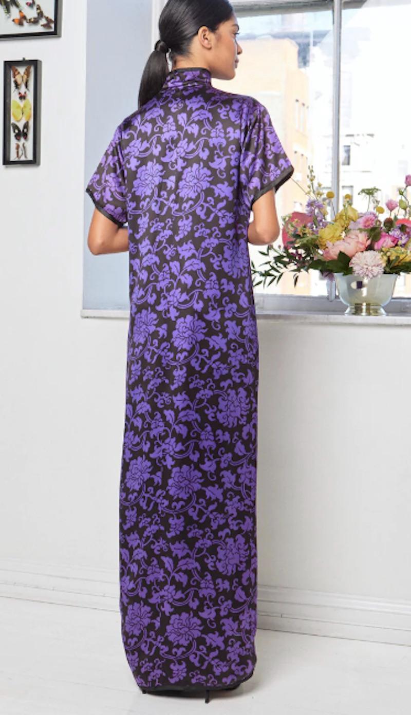 1970s Saint Laurent Rive Gauche evening gown from the Chinese Collection. Chrysanthemum pattern satin fabric in bold purple and black. Features a high neck collar with two tassels and a high middle slit. 

Shoulders 15.5 in
Bust 36 in  
Waist 36
