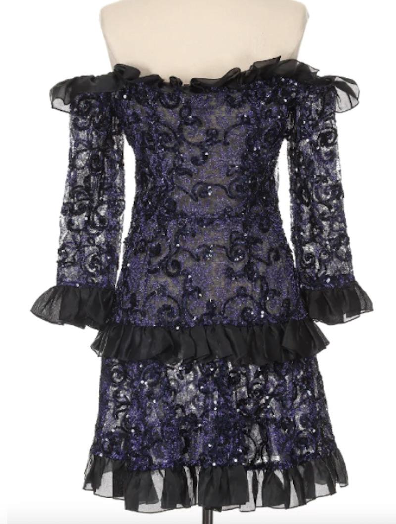 Jaw dropping YSL Rive Gauche Fall 1987 Runway Dress. Stunning and sexy, this little dress encapsulates a time period where more is more! The beautiful navy blue sequins throughout the dress pick up light with movement and the off the shoulder ruffle