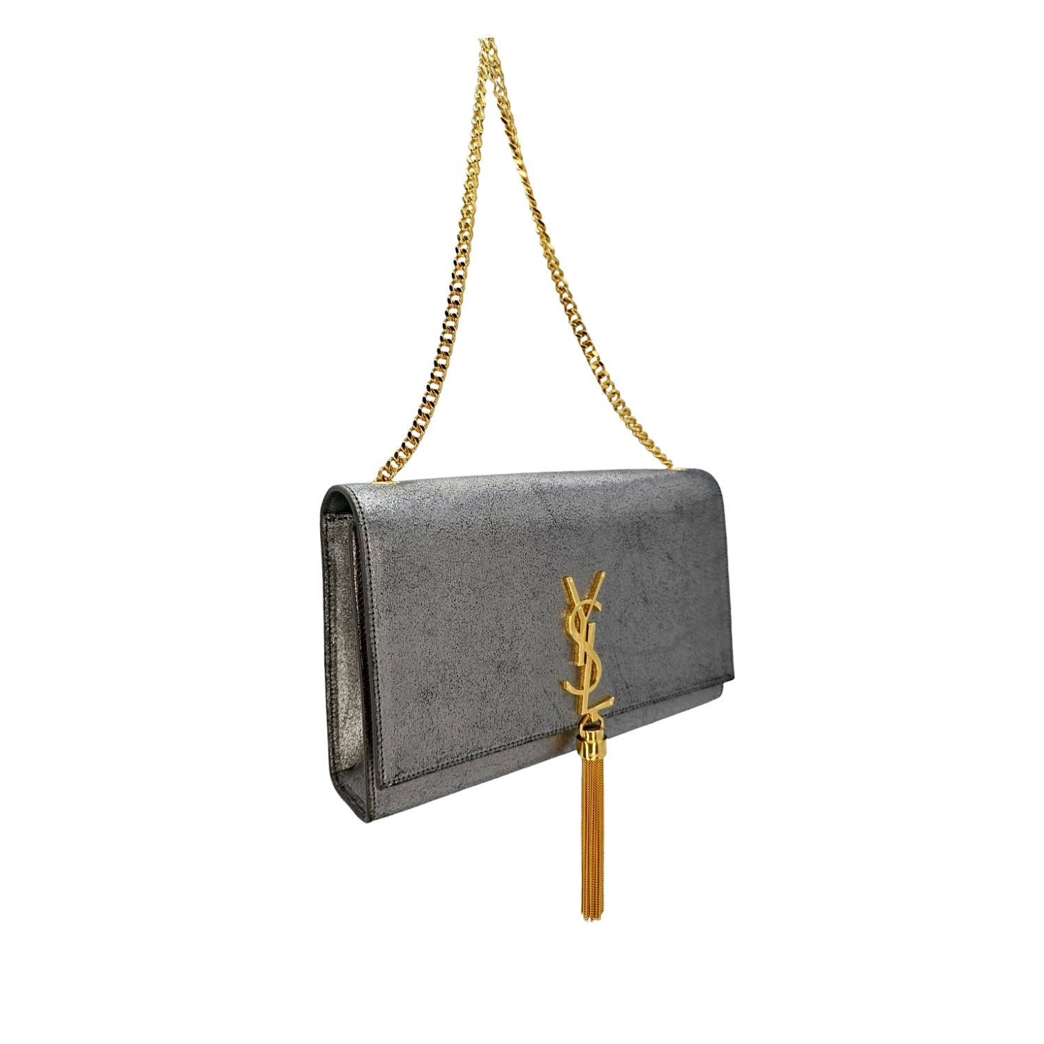 Experience exquisite fashion with this YSL Saint Laurent Medium Kate Chain Shoulder Bag. The iconic insignia and silver metallic leather material add a touch of luxury, while the perfect proportions and spacious interior make it both stylish and