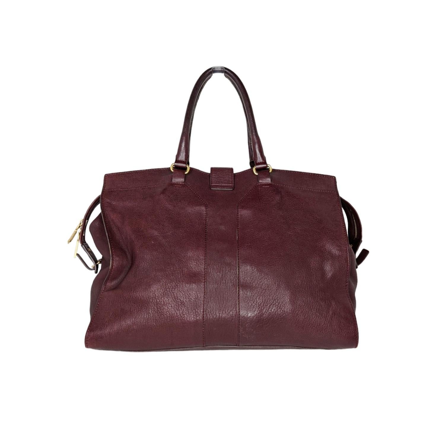 This chic tote is crafted of smooth sheepskin leather in Burgundy. The bag features rolled leather top handles with a gold weighted Y pendant. This opens to a spacious fabric interior with a zipper and patch pockets.

Designer: YSL Saint