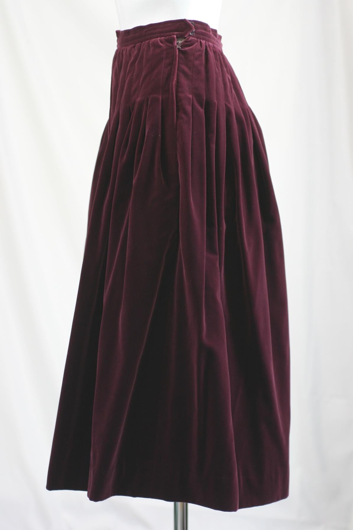 Yves Saint Laurent Russian Collection Pin tucked Wine Velvet skirt. Lays flat across hips and releases to fullness below. Color is off on images. The rich wine color is closest in label image. Size 34 France, 70% cotton 30% rayon. 
Waist 22
