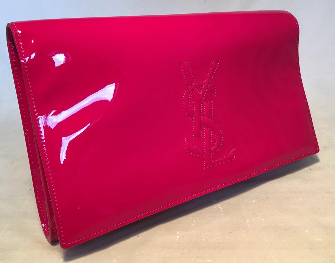 YSL Yves Saint Laurent Hot Pink Patent Leather Clutch in very good condition. hot pink patent leather with embossed YSL logo on front. Snap flap closure opens to a pink satin interior with one slit pocket. No smells or scuffs, clean corners edges
