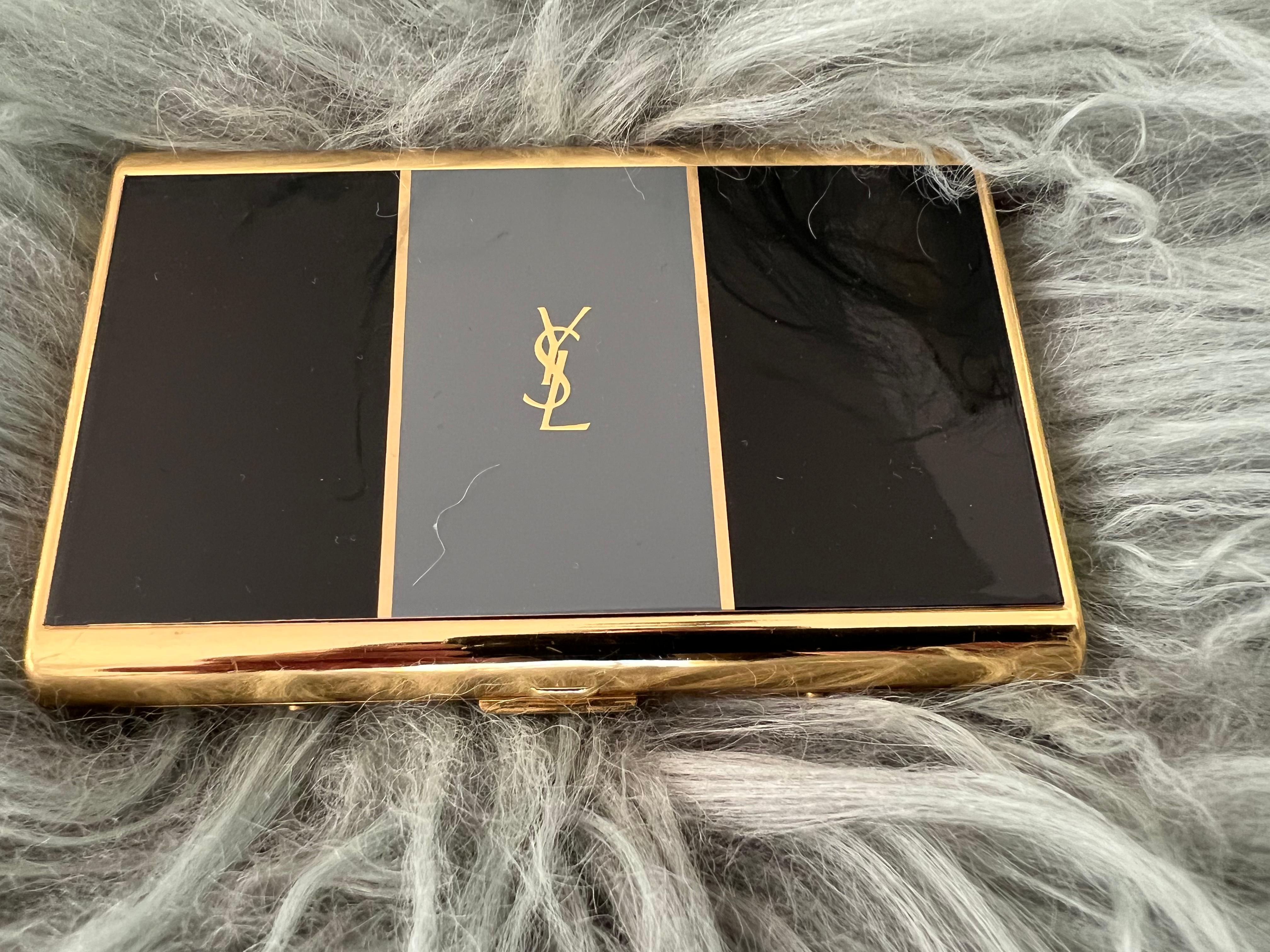“YSL” Yves Saint Laurent retro cigarette case 
Logo Cigarette Case Gold Black Blue
The case is in mint condition. 
The clasp snaps as new. 
Retro. 
1970s
Gold plated. 
Signed YSL.
Very elegant and perfect for a unique classic gift. 