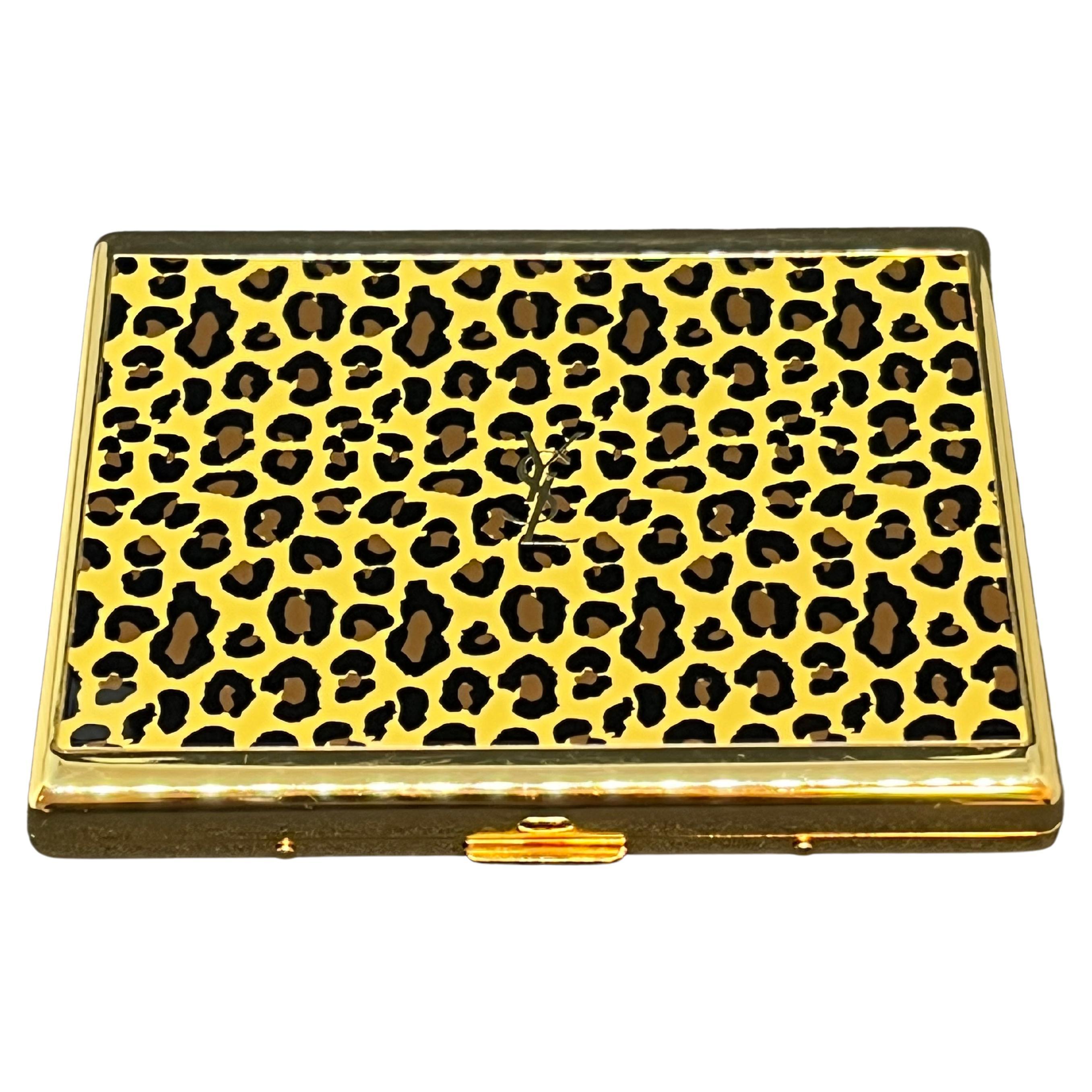 “YSL” Yves Saint Laurent Gold Plated Retro Cigarette Case
Logo Cigarette Case “Jungle” print 
The case is in mint condition. 
The clasp snaps as new. 
Retro. 
1970s
Gold plated. 
Signed YSL.
Very elegant and perfect for a unique classic gift. 