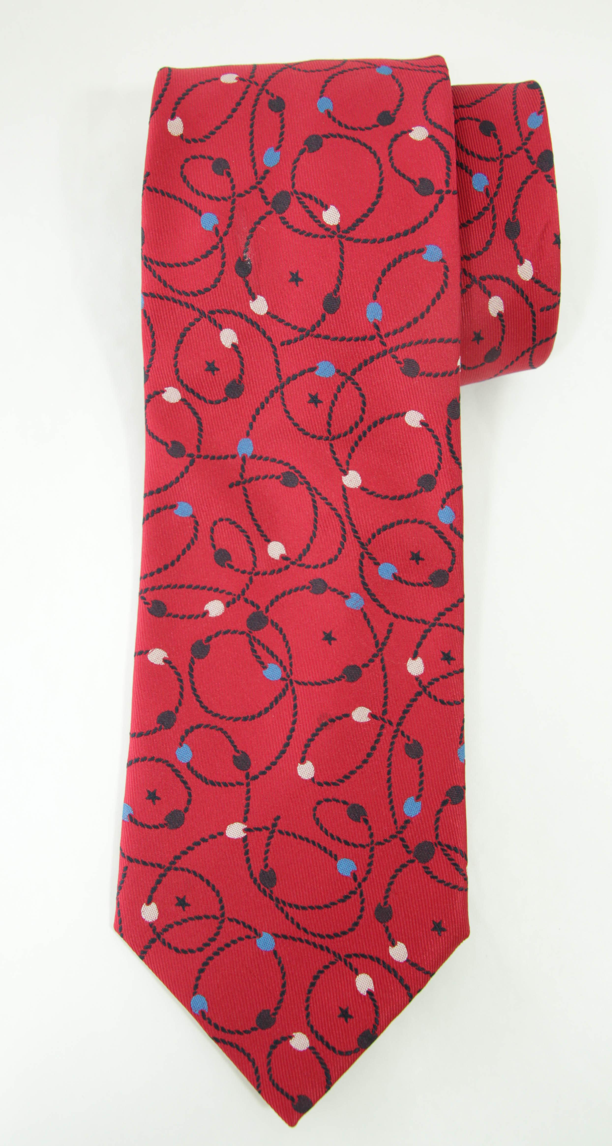 Vintage YSL silk tie with abstract Post Modern detailing to create a timeless tie. 
YSL Yves Saint Laurent Necktie Mens Silk Abstract design.
Authentic, preowned, vintage Yves Saint Laurent necktie, most likely made in the 1980s. 
Moroccan red with