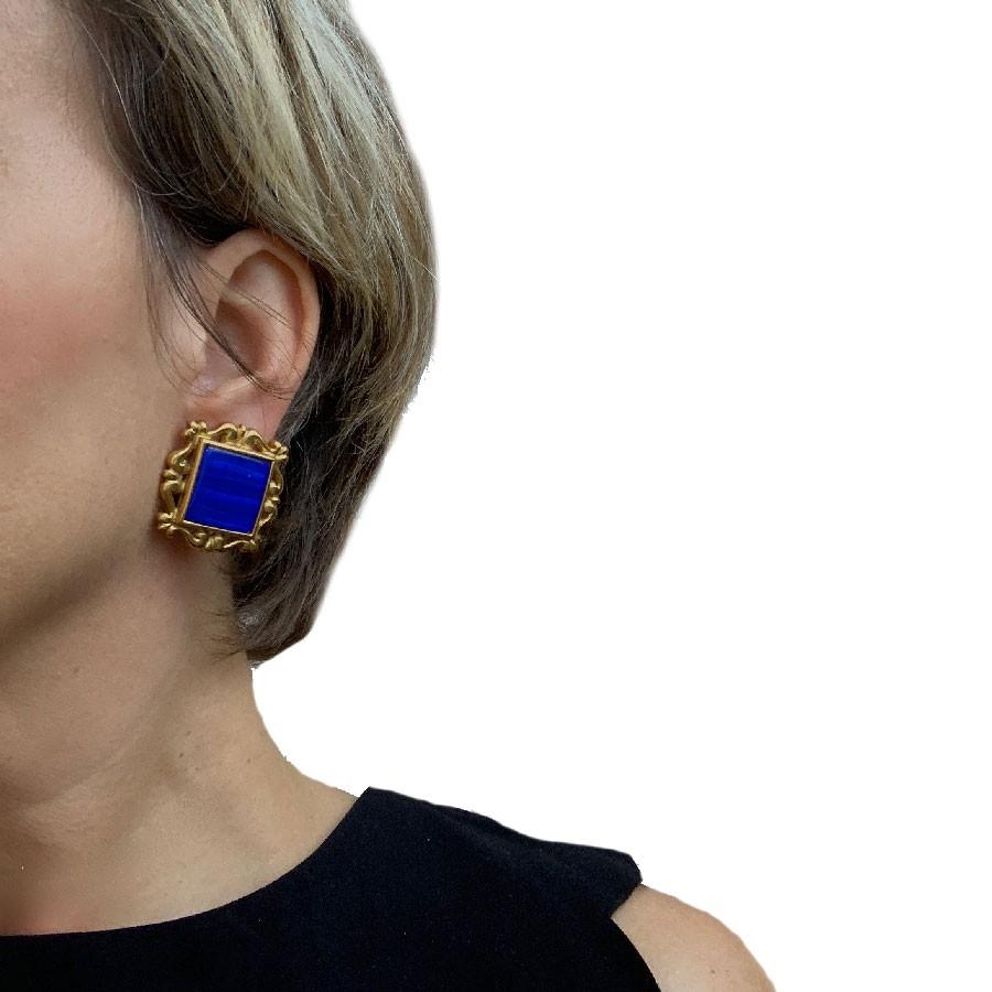 YSL Yves Saint Laurent aesthetic vintage clip-on earrings in gilt metal and a beautiful piece in blue resin in the center that enhances this jewel. 
The brand is engraved on the back of each earring.

They are in good condition. Micro scratches are