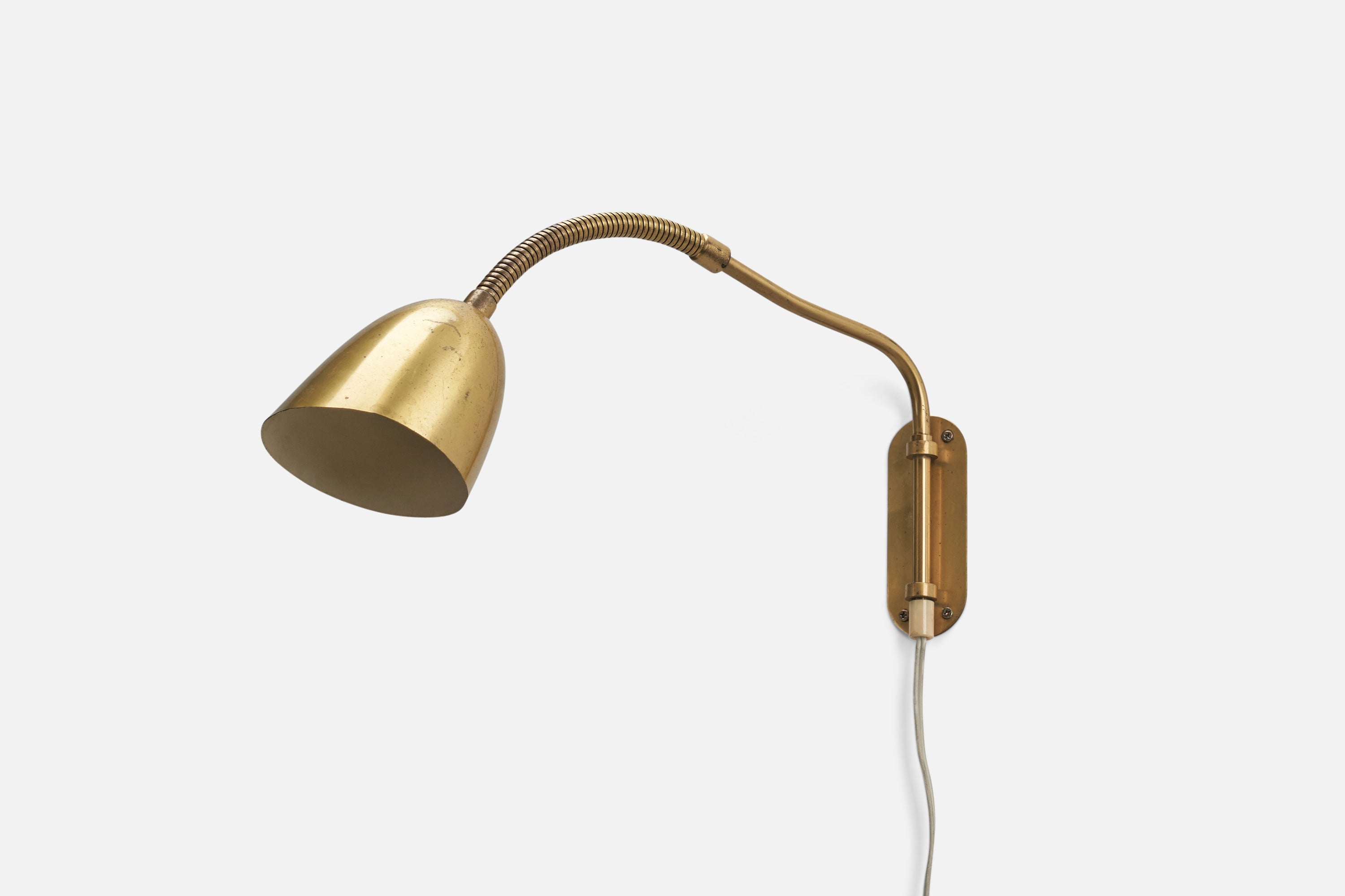An adjustable brass wall light / sconce designed and produced by Ystad Metall, Sweden, 1940s. Fixture with makers stamp to backplate.

Dimensions of Back Plate (inches): 5.06 x 1.88 x 0.05 (Height x Width x Depth)

Socket takes standard E-26