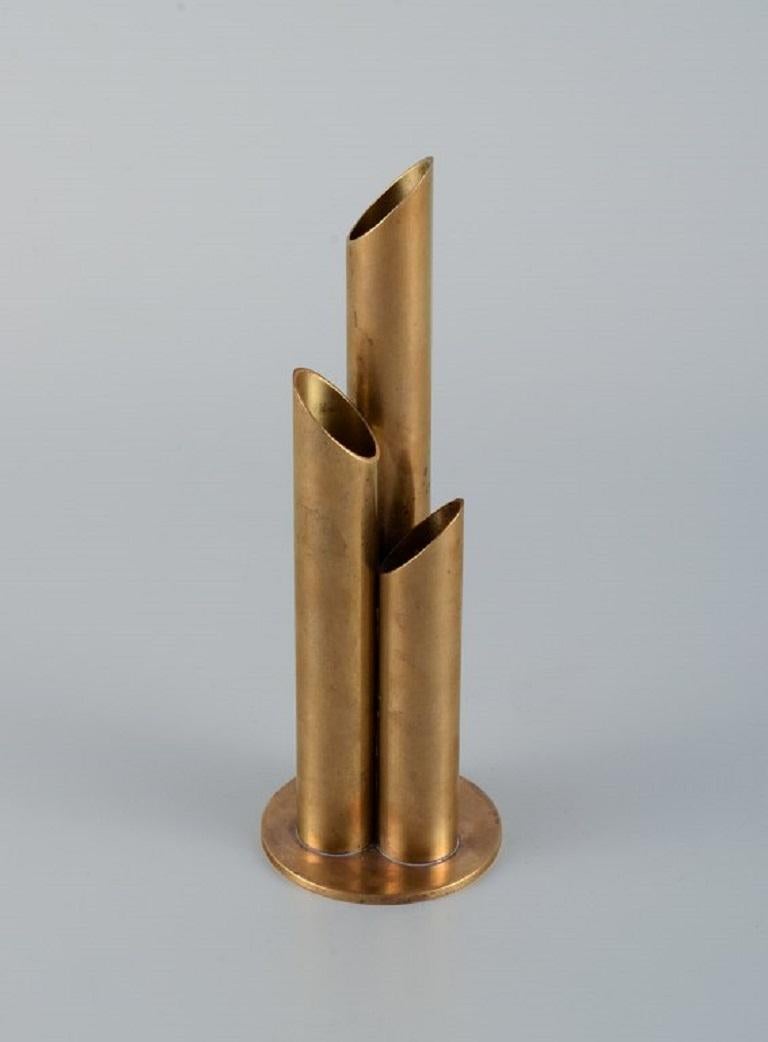 Ystad Metall, brass vase for 3 flower stems.
1970s, 
Measurements: H 19.5 x D 6.5 cm.
Marked.
Beautiful patina.