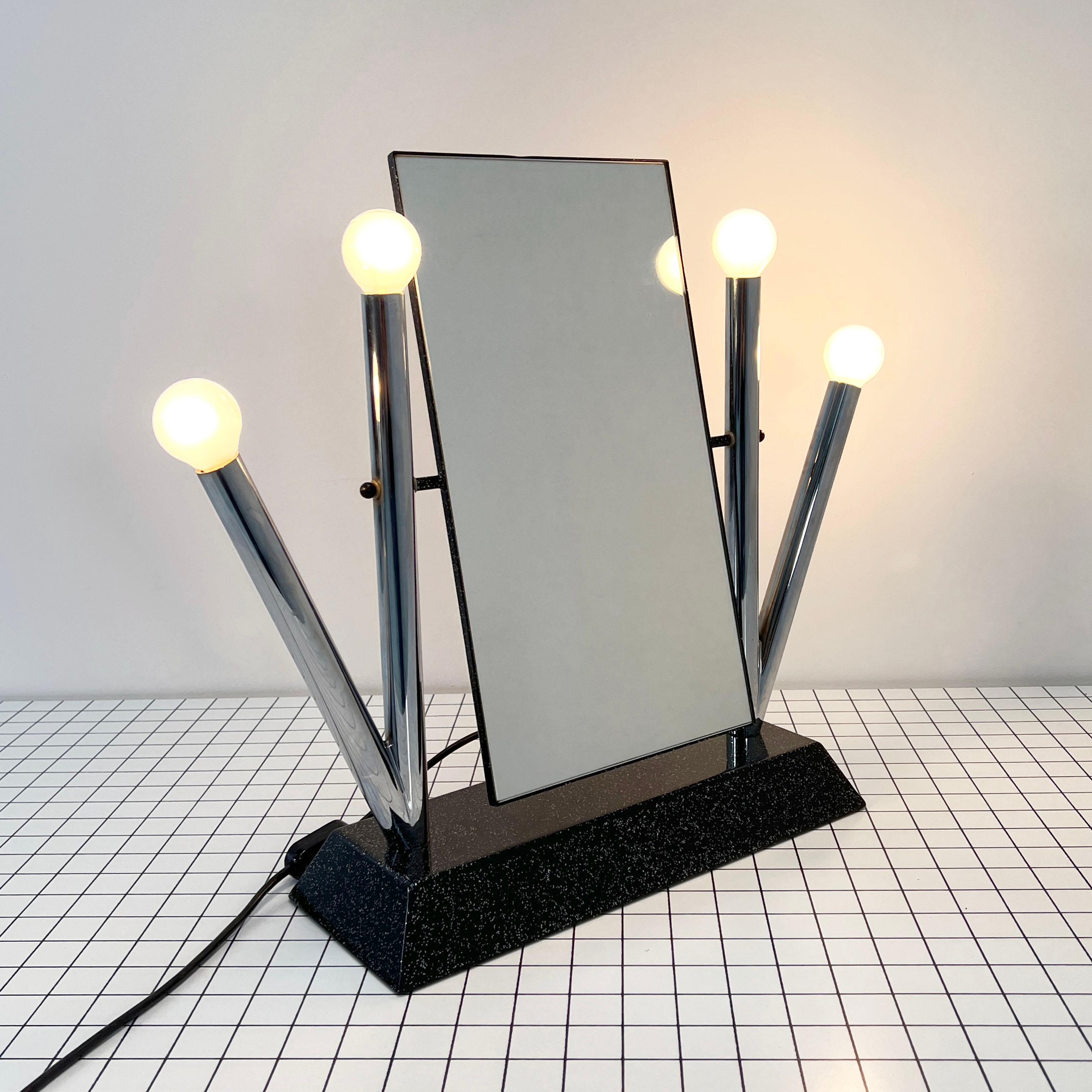 Designer - Anna Anselmi
Producer - Bieffeplast
Model - Yucca Table Mirror
Design Period - Eighties
Measurements - Width 40 cm x Depth 15 cm x Height 49 cm
Materials - Steel, Mirror 
Color - Silvor, Black
Electrical Properties - European Plug (up to