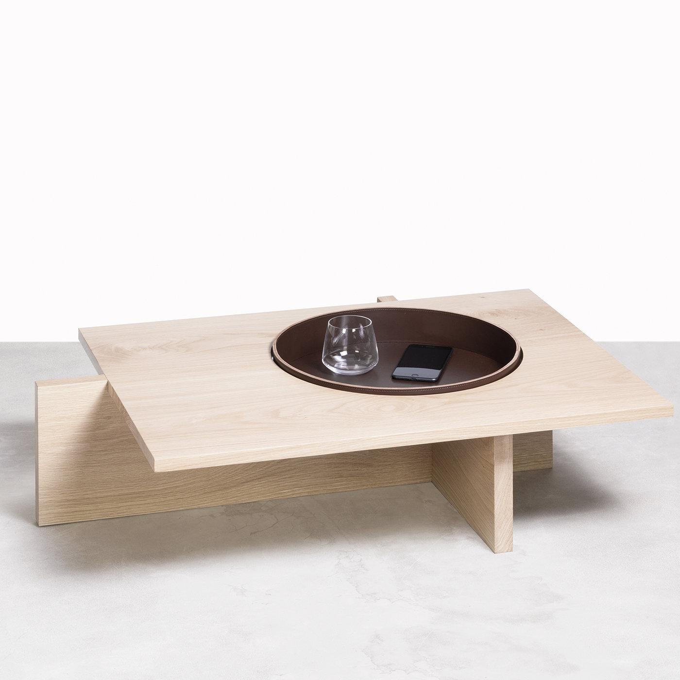 A unique structure made by planes intersected with each other and made of ash wood and natural wood. The saddle leather tray completes this wonderful coffee table. The Rabitti 1969 products are all made with vegetable tanned saddle leather, which