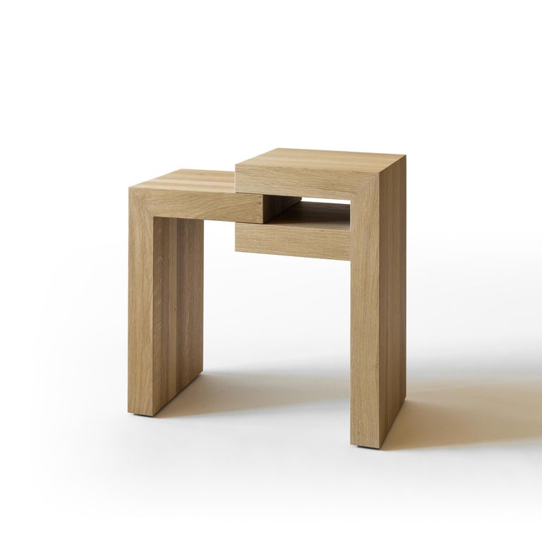 Yume Oak side tables by Joyful Homes
Materials: Solid European Oak - Oiled Finish
Dimensions: D54 x W30 x H54 cm
Also available in different materials. 

Composed of two parts that uniquely connect by a central axis to allow pivoting at