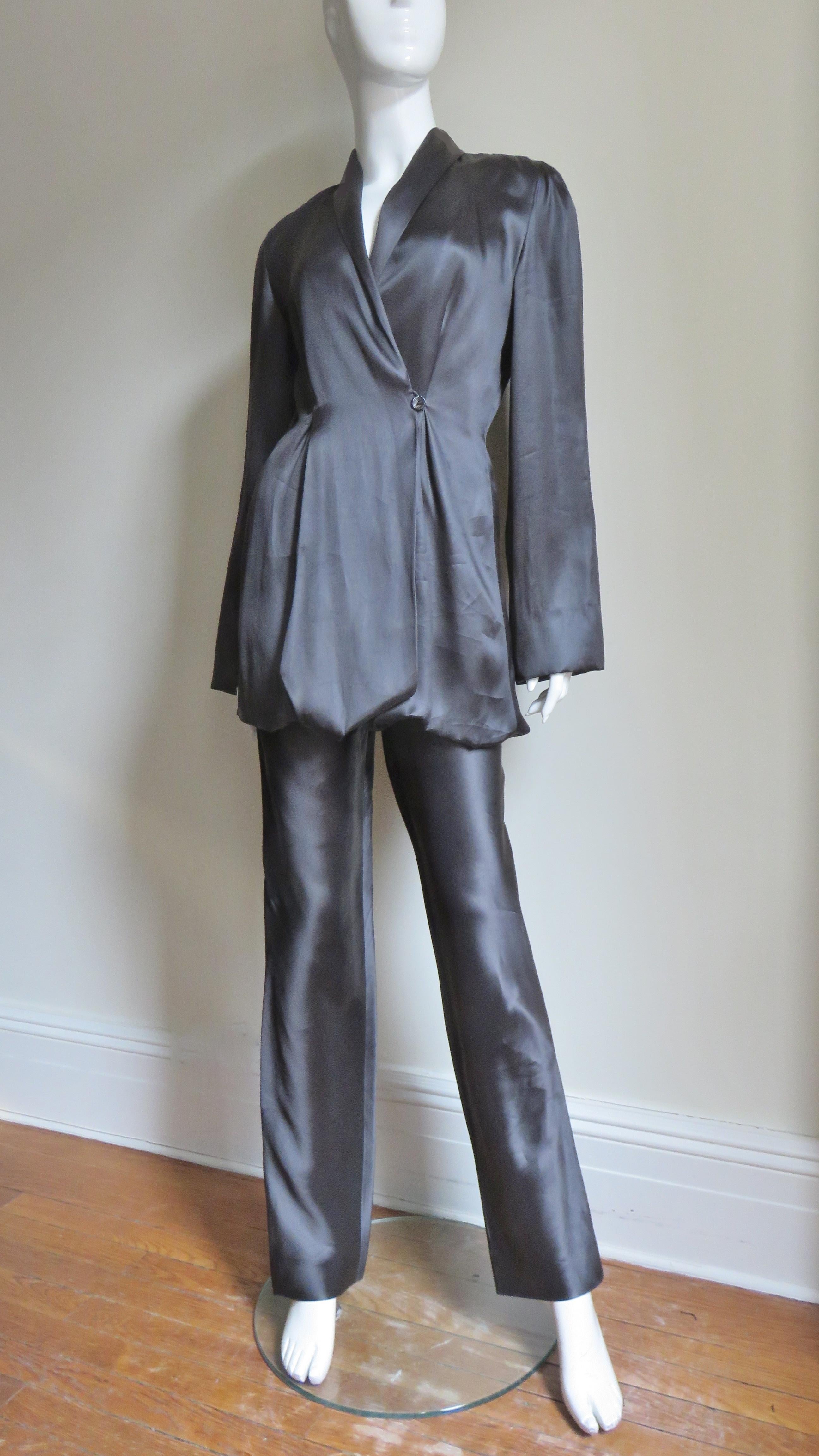 A beautiful black silk pant suit from Yumi Eto. The double breasted shawl collar jacket is gorgeous with matching fine inner adjustable straps which can be moved to different configuration with buttons inside of the jacket to change the hemline