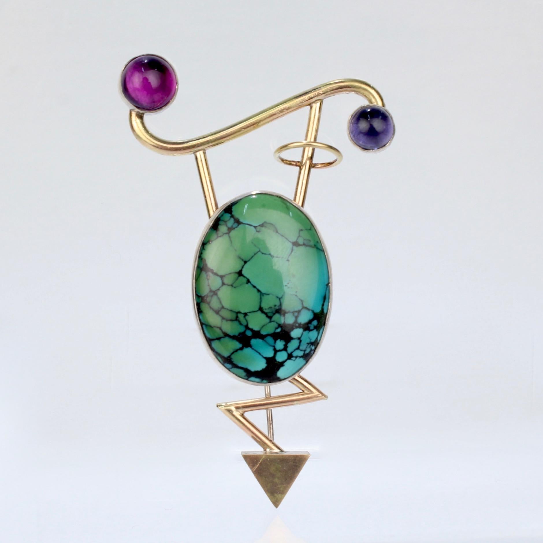 A very fine Retro demi-parure of earrings and a brooch by Yumi Ueno.

Comprised of sterling silver and 14k gold and set with large calico spider web matrix turquoise cabochons. The brooch also has a tourmaline and an amethyst cabochon flanking each
