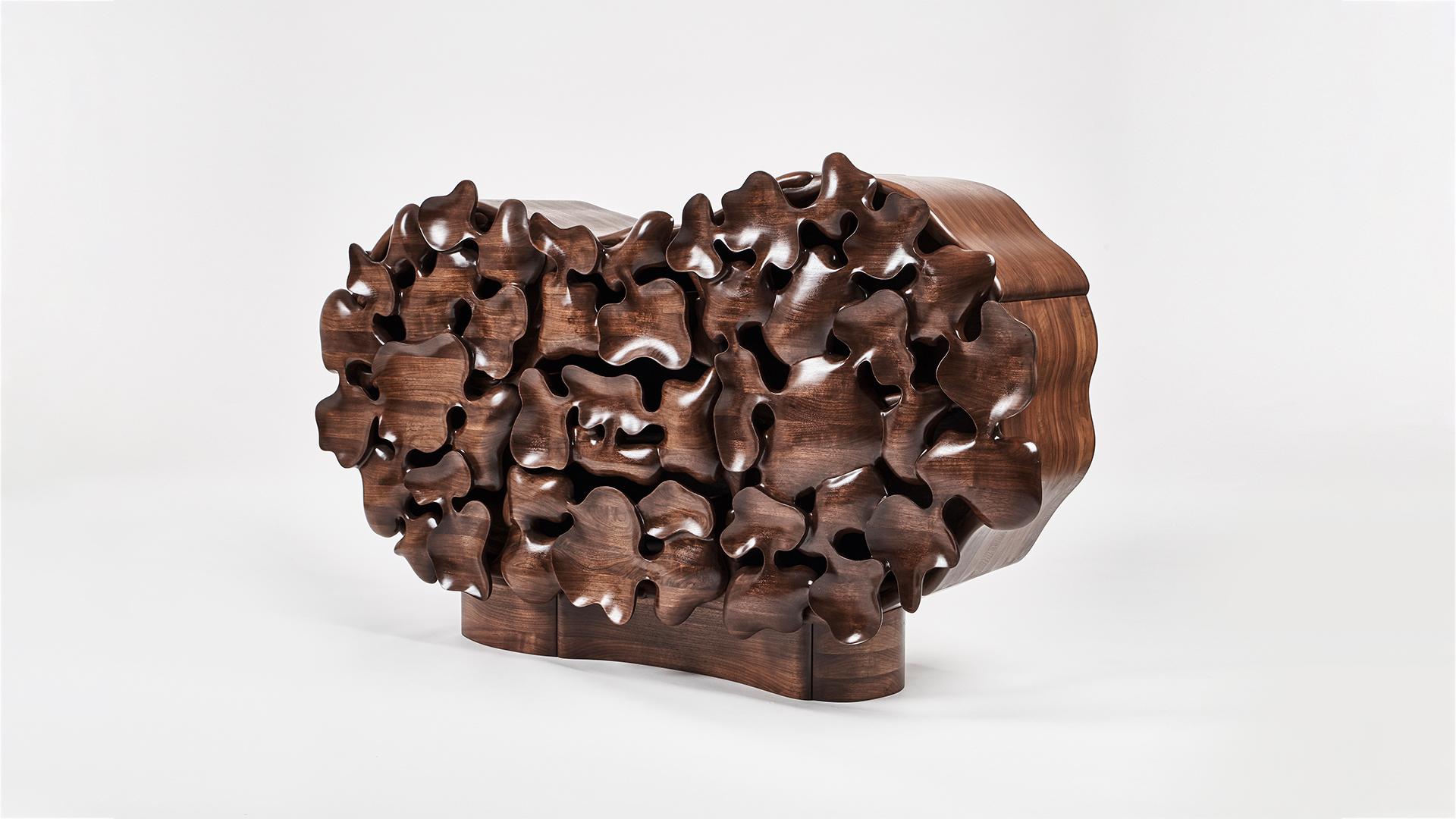 Seoul-based designer Kim Yunhwan’s remarkable hand carved furniture began as series of small objects, trays, vessels, bowls, that had, what he calls, “unintended shapes.” Scrutinizing these objects, Kim found that by connecting them, reversing them