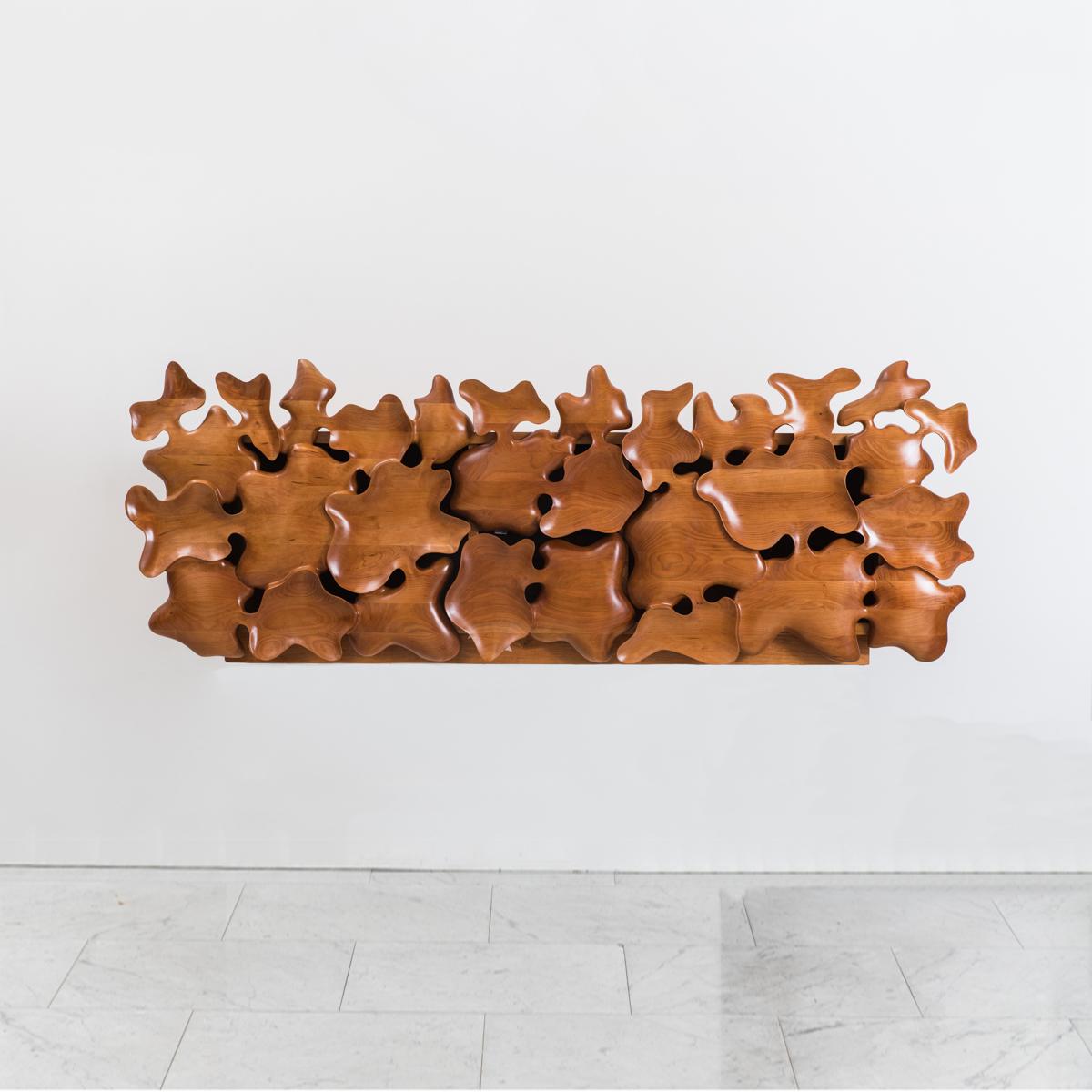 Seoul-based designer Kim Yunhwan’s remarkable hand carved furniture began as series of small objects – trays, vessels, bowls – that had, what he calls, “unintended shapes.” Scrutinizing these objects, Kim found that by connecting them, reversing