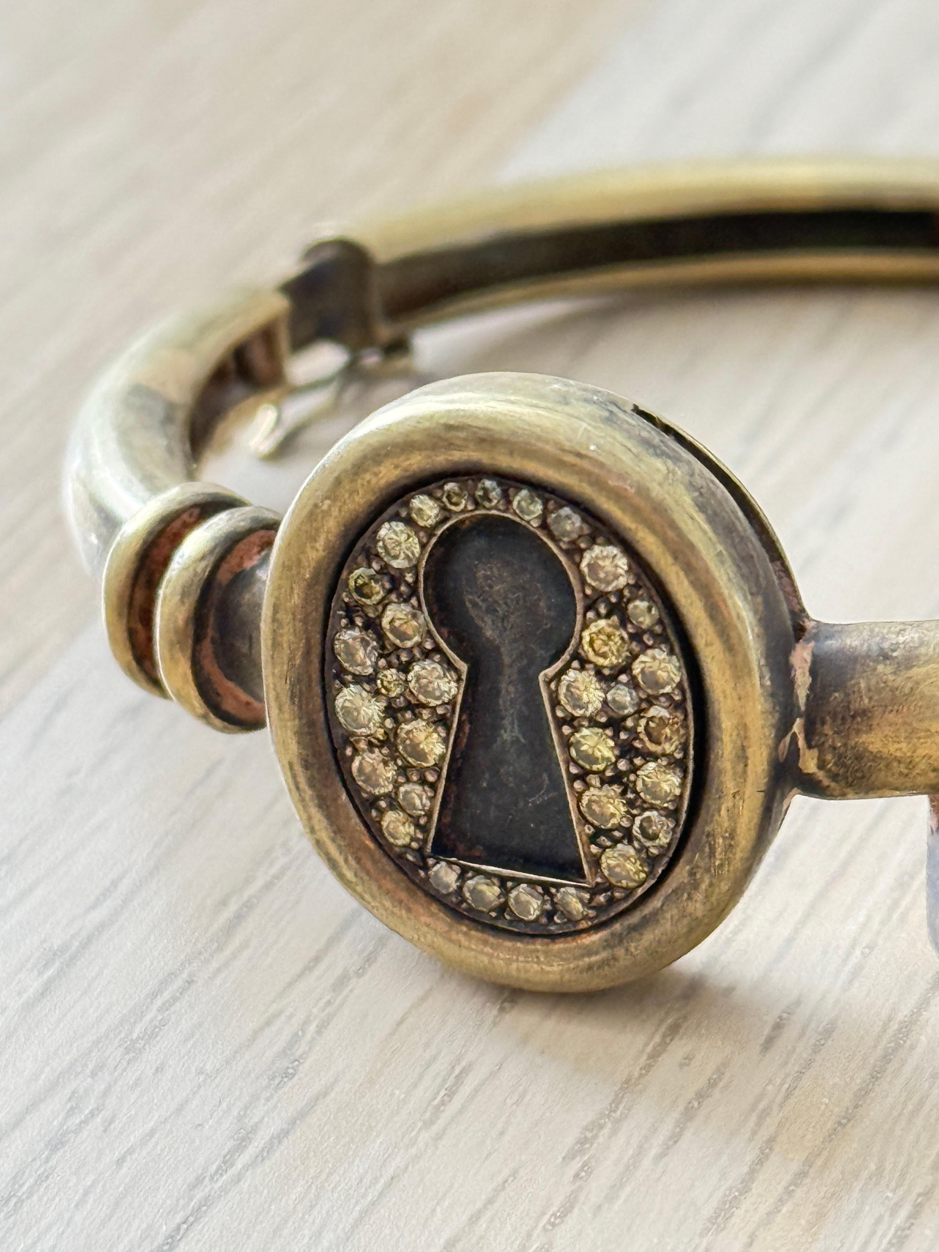 An extraordinary bracelet by acclaimed artist Yuri Kuper, crafted in luxurious gold and delicately set with diamonds. Designed in the evocative shape of a lock and key, this piece is more than fine jewelry — it is a wearable sculpture, imbued with