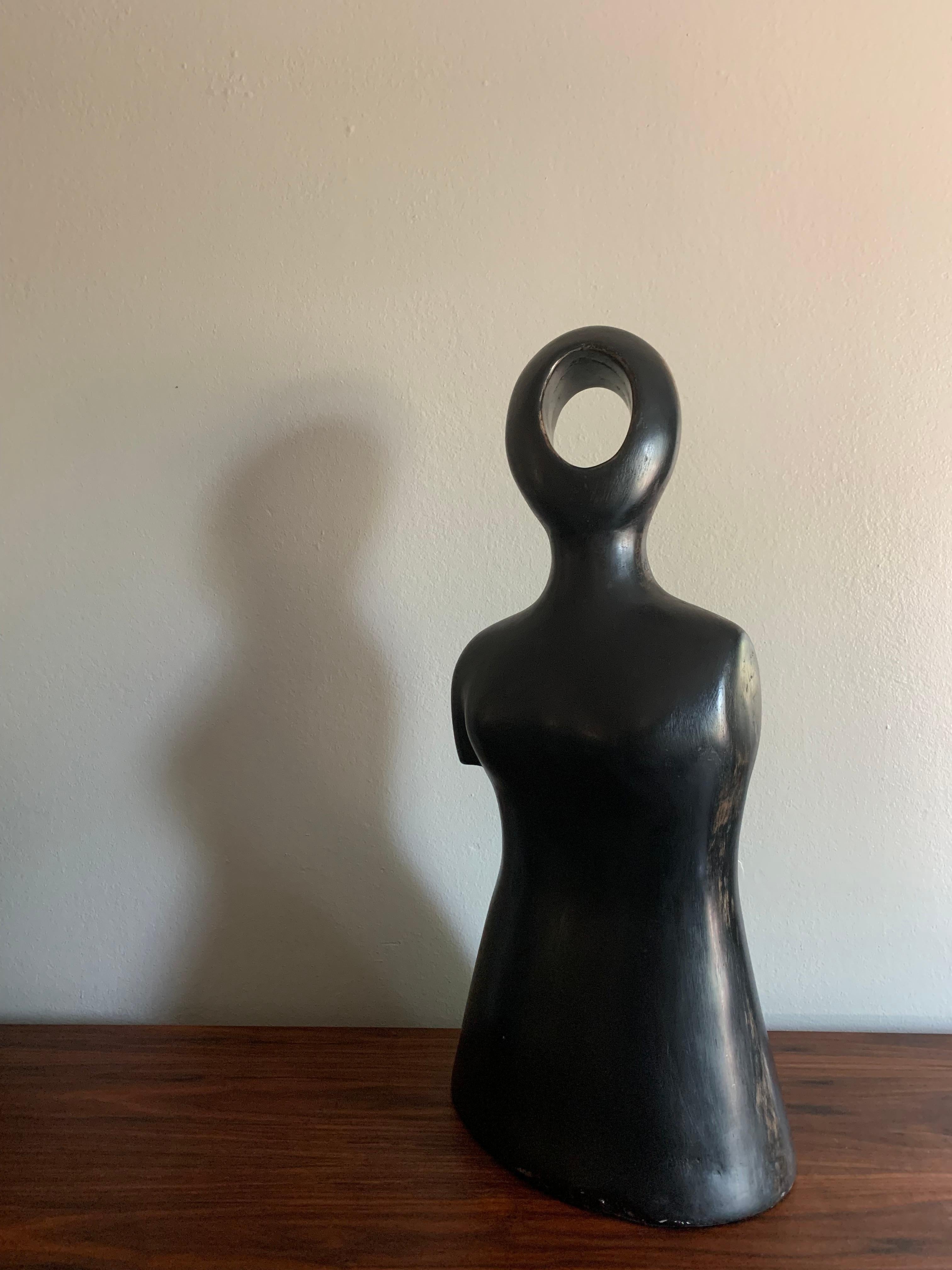 A sculpture of a figure by Yuri Zatarain from the Black Line. Made of resin with a huengue finish. This piece has been authenticated by Yuri Zatarain's gallery.