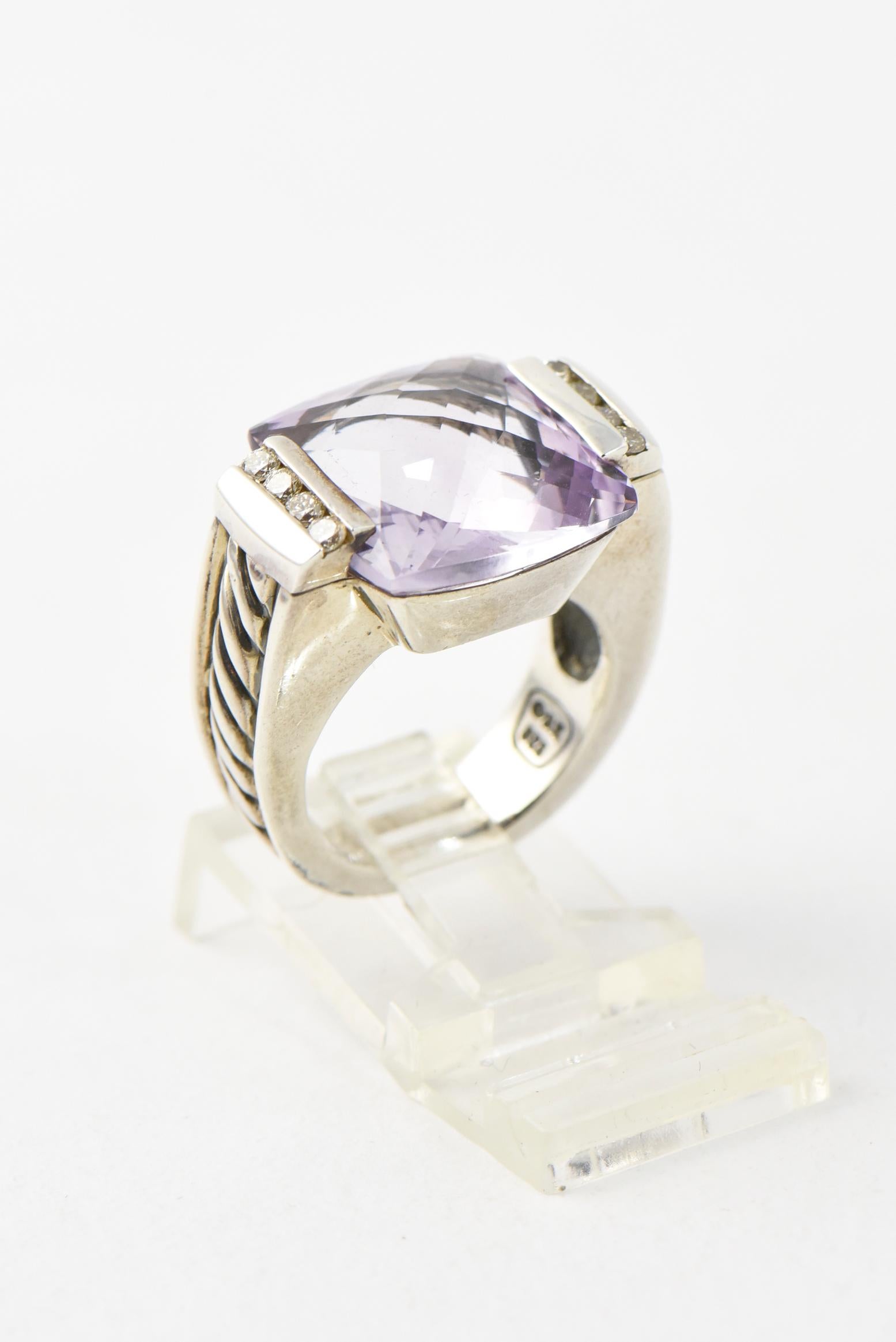 David Yurman sterling silver cocktail ring from the Deco collection. Features a cushion-shaped amethyst  center with channel-set round brilliant diamonds at sides and cable motif throughout shank. 
Size: 5.5
Hallmarked: 585, 925 along with brand