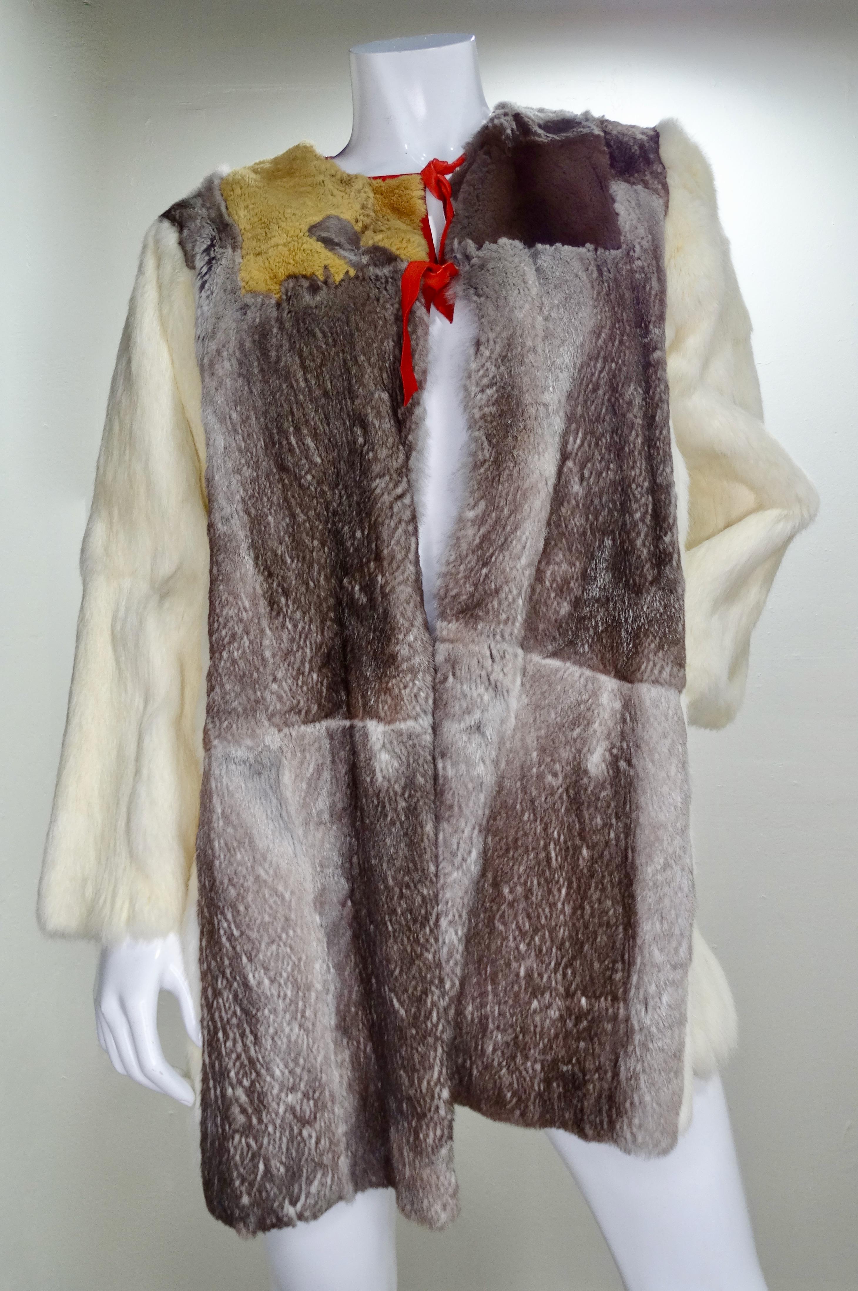 Show off this Yvan & Marzia Paris treasure all winter long! Circa 1980s, this jacket is crafted from various Rabbit pelts to create a color block pattern with a panda motif on the back. Includes front slit two pockets and a red leather trim with