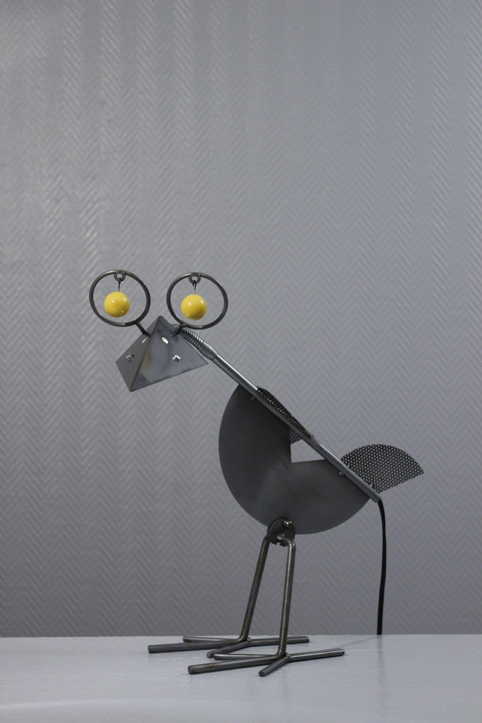 Yvan Pestalozzi “Raven” design lamp, Birdie design series 1992, Lacri Italy production 1995. 

The spout acts as an adjustable reflector and the lamp pivots on its legs. 